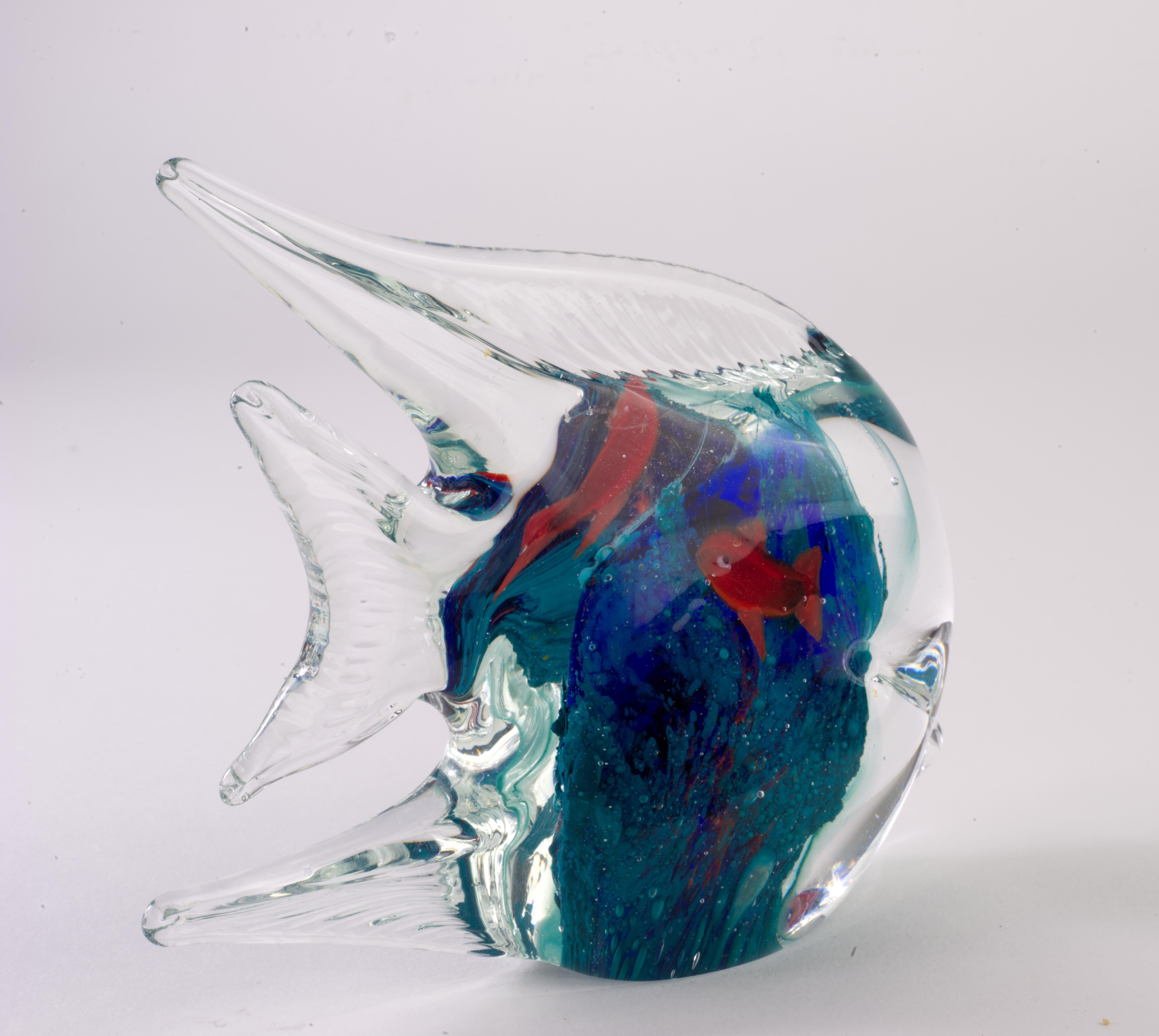  Festive teal, cobalt, and red tropical fish figurine or paperweight is made in sommerso technique; colored glass gather, dipped into pigments, is cased over with clear glass. Small murine in shape of red fish with black and white eyes is added on