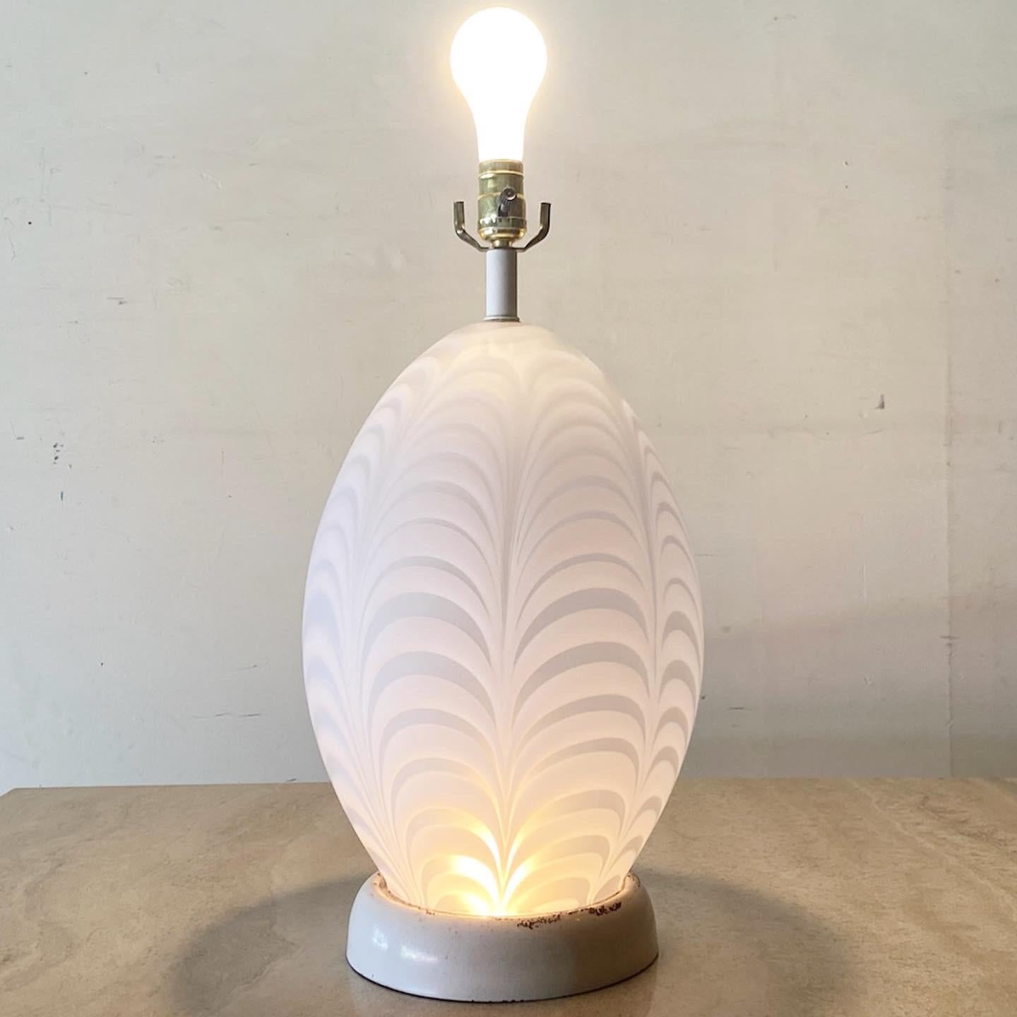 Incredible Murano style glass table lamp. Body of lamp is a glass egg shape with a light inside the body as well. less

