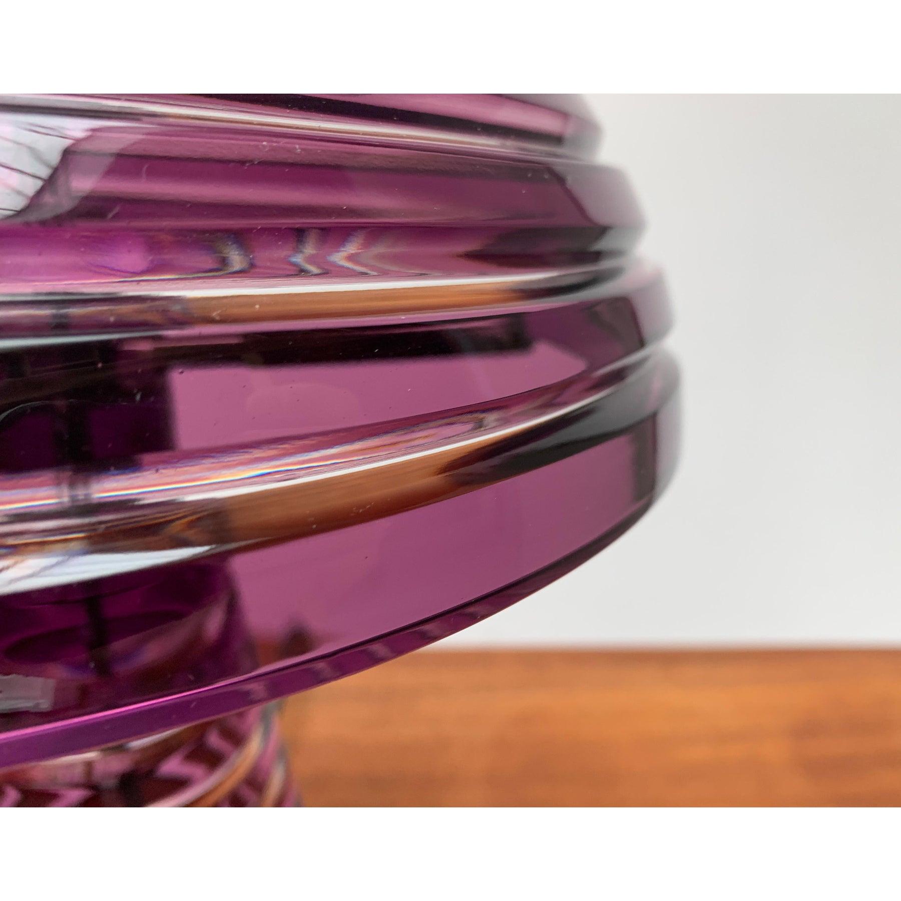Imponente lámpara de sobremesa de cristal de origen italiano.

La pantalla y el pie de la luminaria son de vidrio coloreado y presentan una estructura de ranuras circunferenciales. En contraste con las superficies de cristal violeta, la ranura se