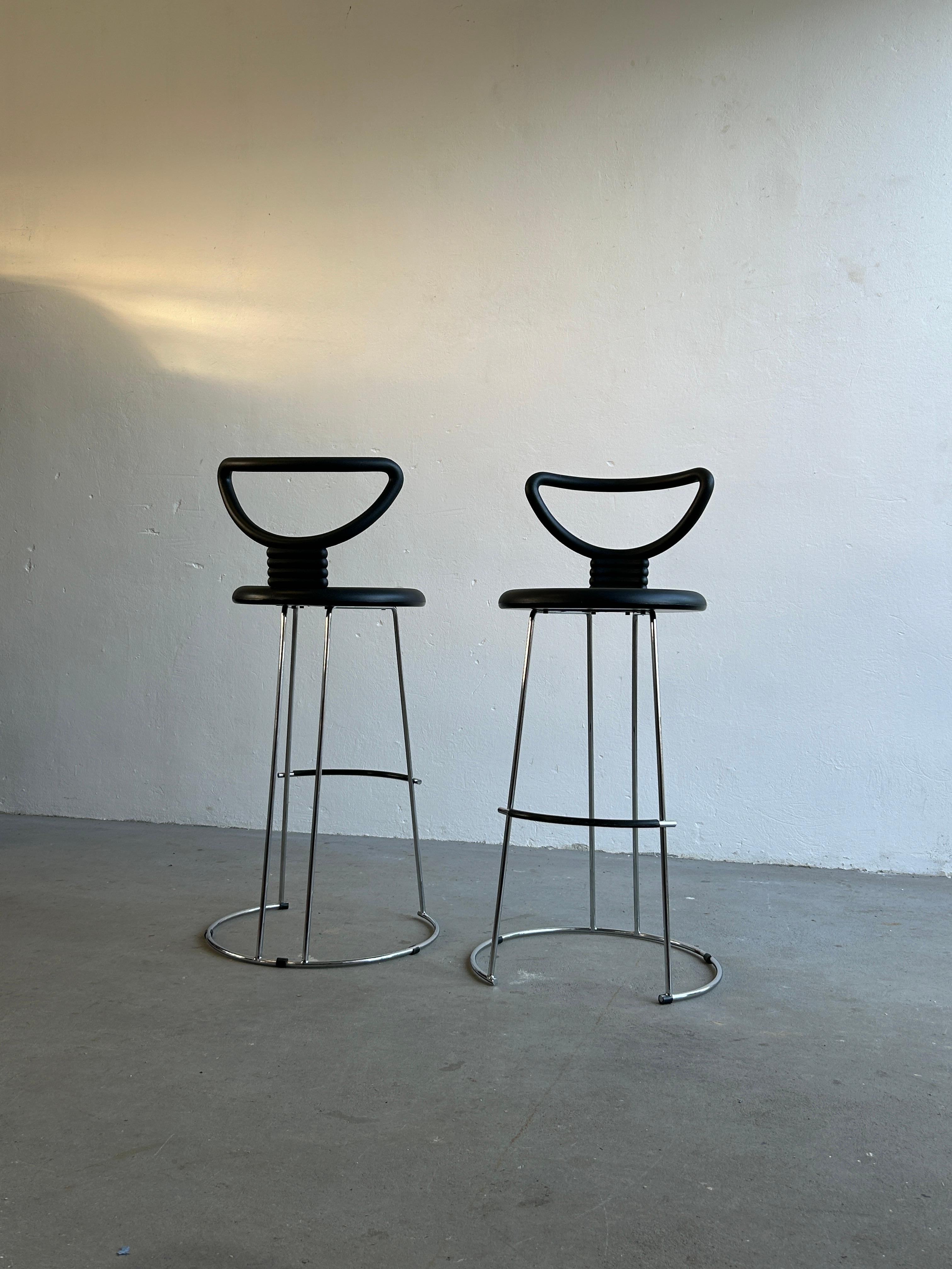 A pair of 'Nardis' bar height stools with rubber like seats on a polished chrome frame designed by Nobu Tanigawa for Fasem Italy.
Unique postmodern design combined with great comfort.

The chairs have a sturdy steel frame with a durable rubber