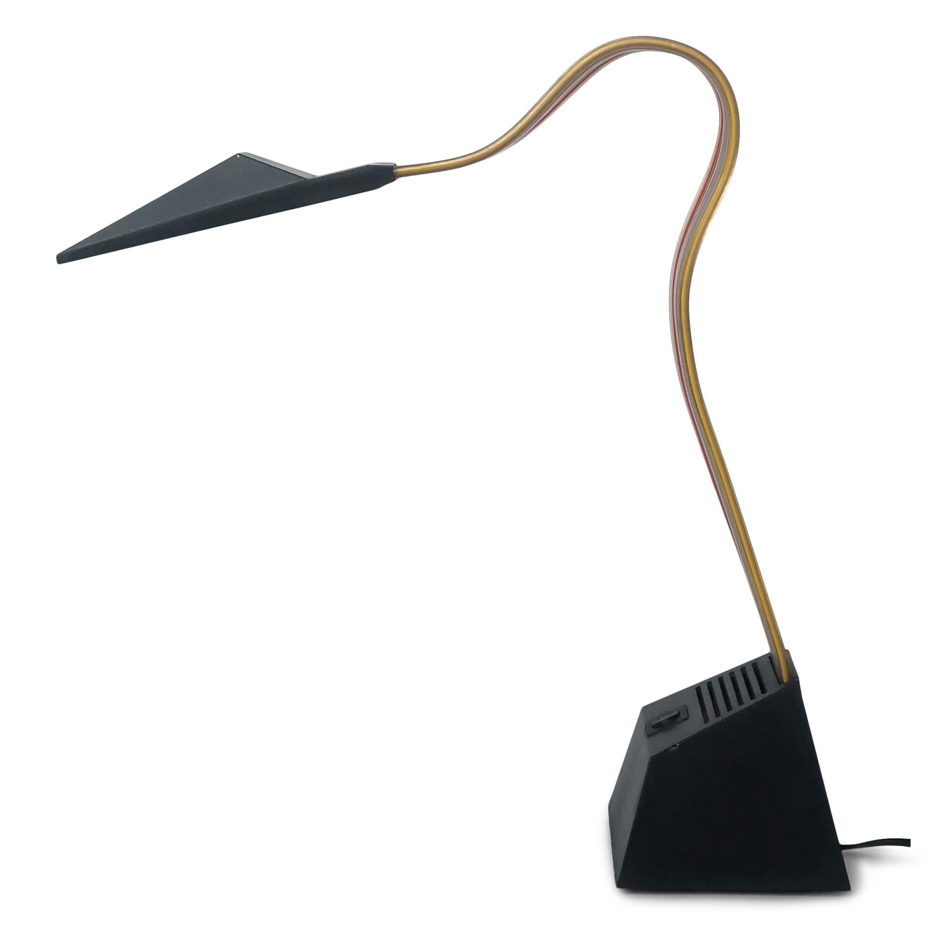 A quintessentially postmodern table lamp, the Nastro was designed by Alberto Fraser for Stilnovo in 1983. Made in Italy, it has a weighted black plastic base, black plastic shade and a rainbow striped flexible and bendable PVC stem. Alberto Fraser