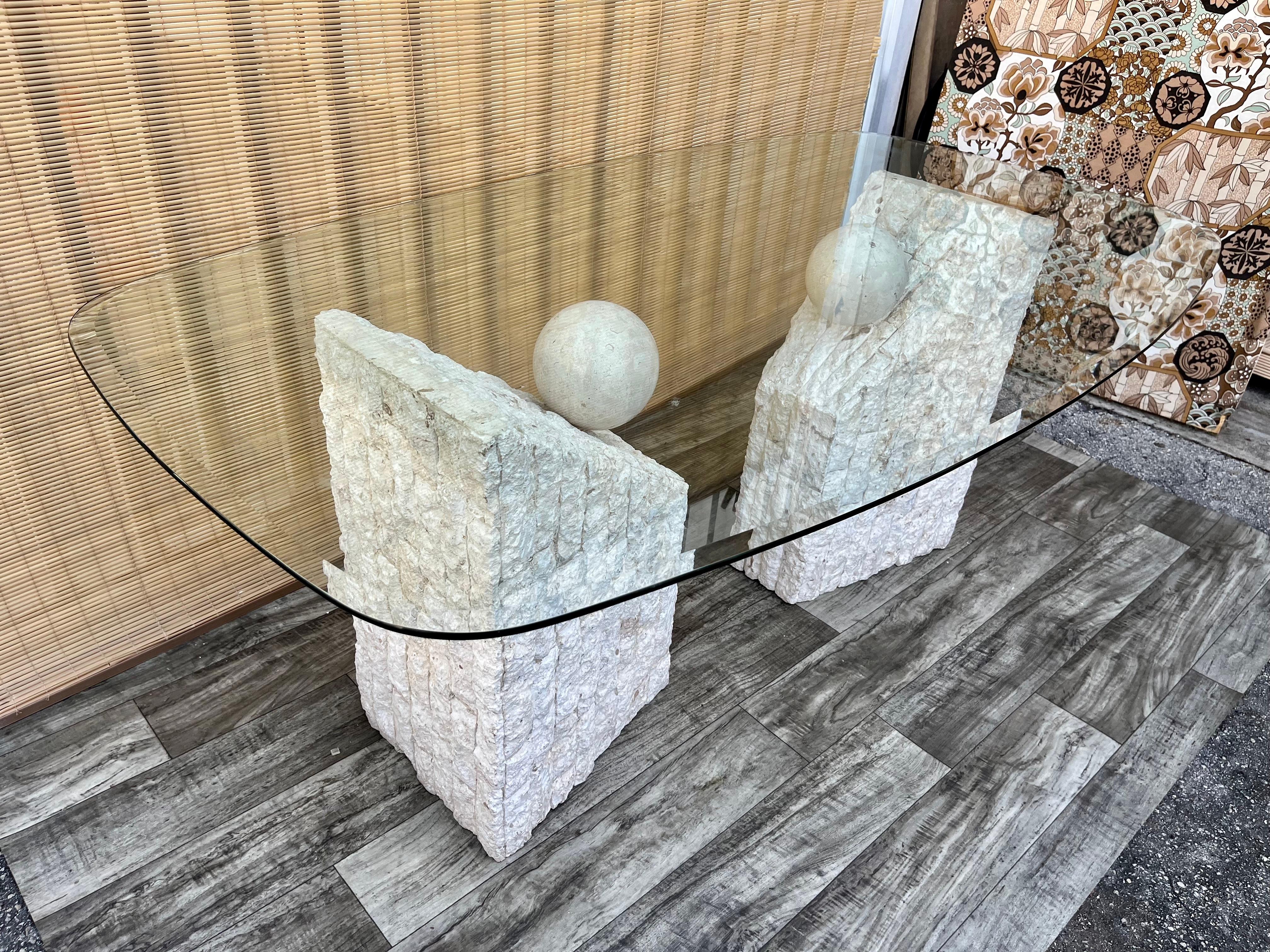 Beveled Postmodern Natural Mactan Stone Glass Top Dining Table w/ Pedestals. Circa 1980s