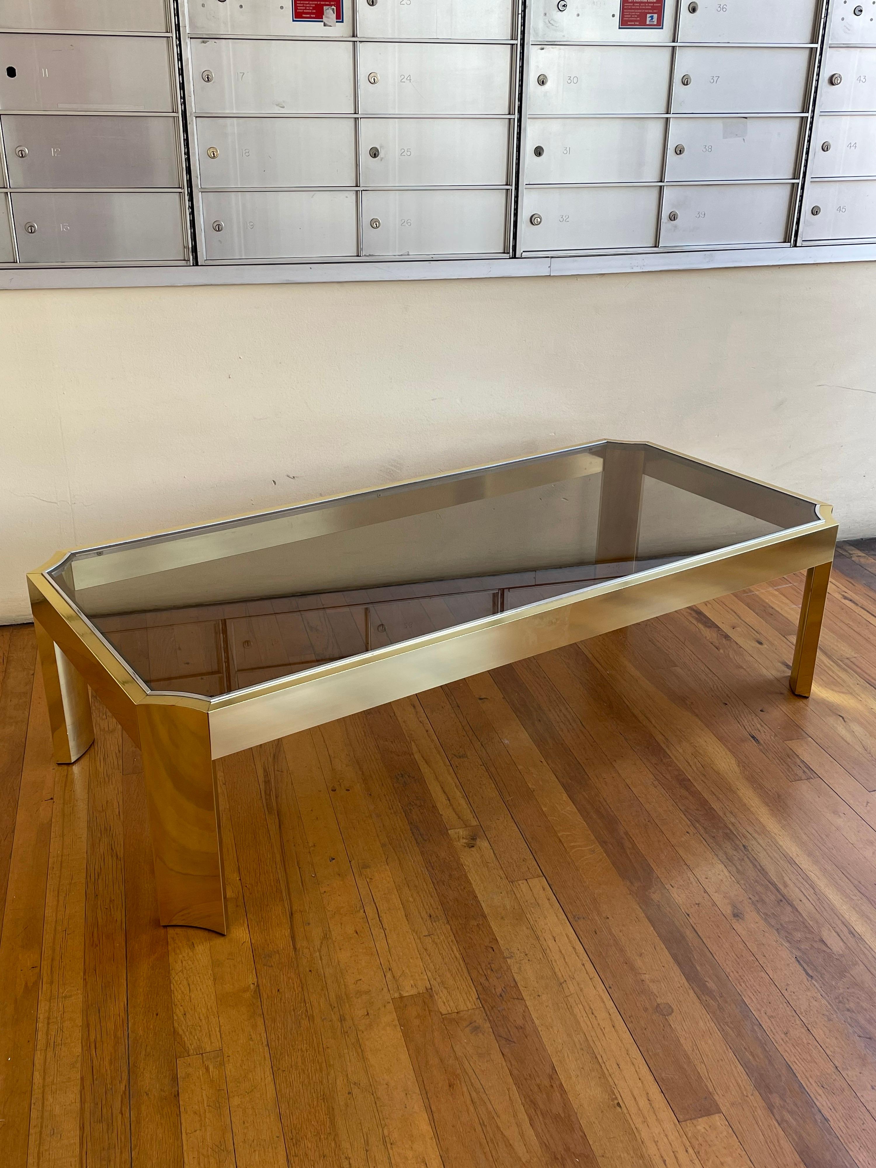 Incredible anodized aluminum with brass finish and chrome trim coffee table with smoke glass top, circa 1970's very clean condition concave legs rare piece.