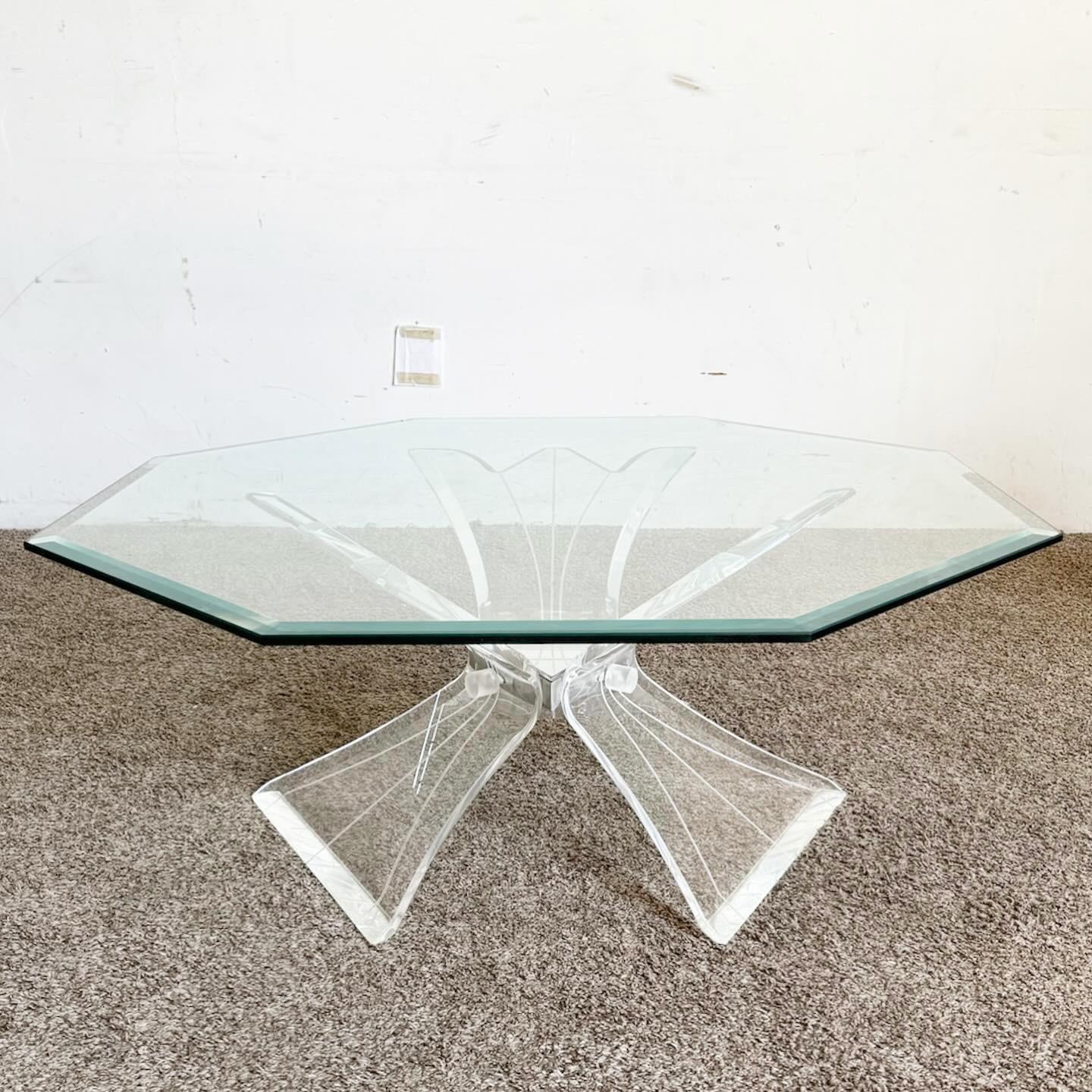 The Postmodern Octagonal Beveled Glass Top Lucite Coffee Table is a testament to bold postmodern design. Its unique octagonal shape and transparent lucite frame create a striking, modern look. The beveled glass top adds sophistication, while the