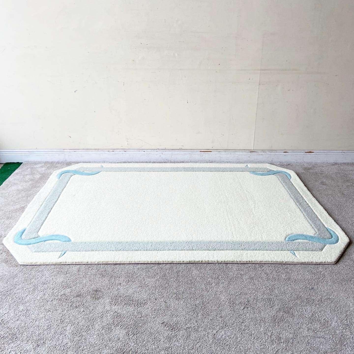 Outstanding vintage postmodern sculpted area rug. Features an off white center and edge with a gray border cornered by a serpentine aqua blue ribbon.

Rug 3
