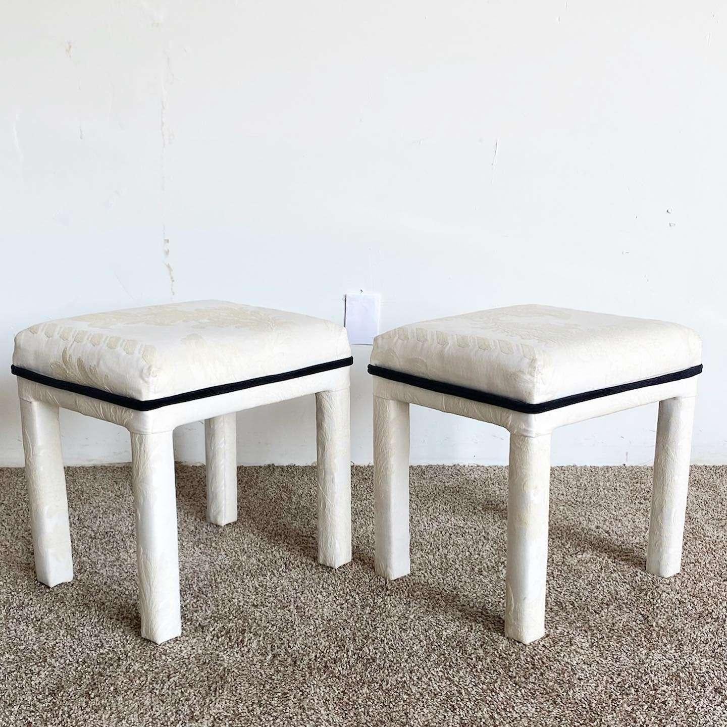 Exceptional pair of vintage postmodern parsons low stools. Each feature an off white floral fabric with black accenting.