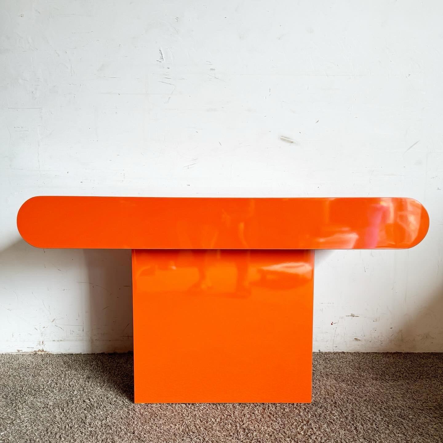 Elevate your space with the Postmodern Orange Lacquer Laminate Bullnose Console Table, a vibrant addition that combines bold color with sleek design. Its minimalist aesthetic and striking orange finish make it a perfect statement piece for any