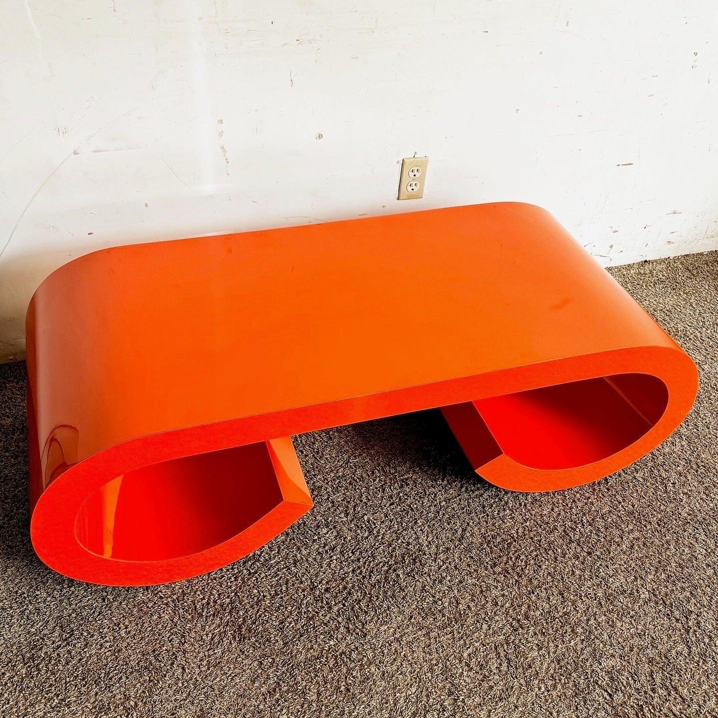 Discover the Postmodern Orange Lacquer Coffee Table with a scroll waterfall design, epitomizing 1980s aesthetics for your modern home.
 
 We sell items as acquired, without restoring or repairing. Vintage pieces may have age-related wear. Review