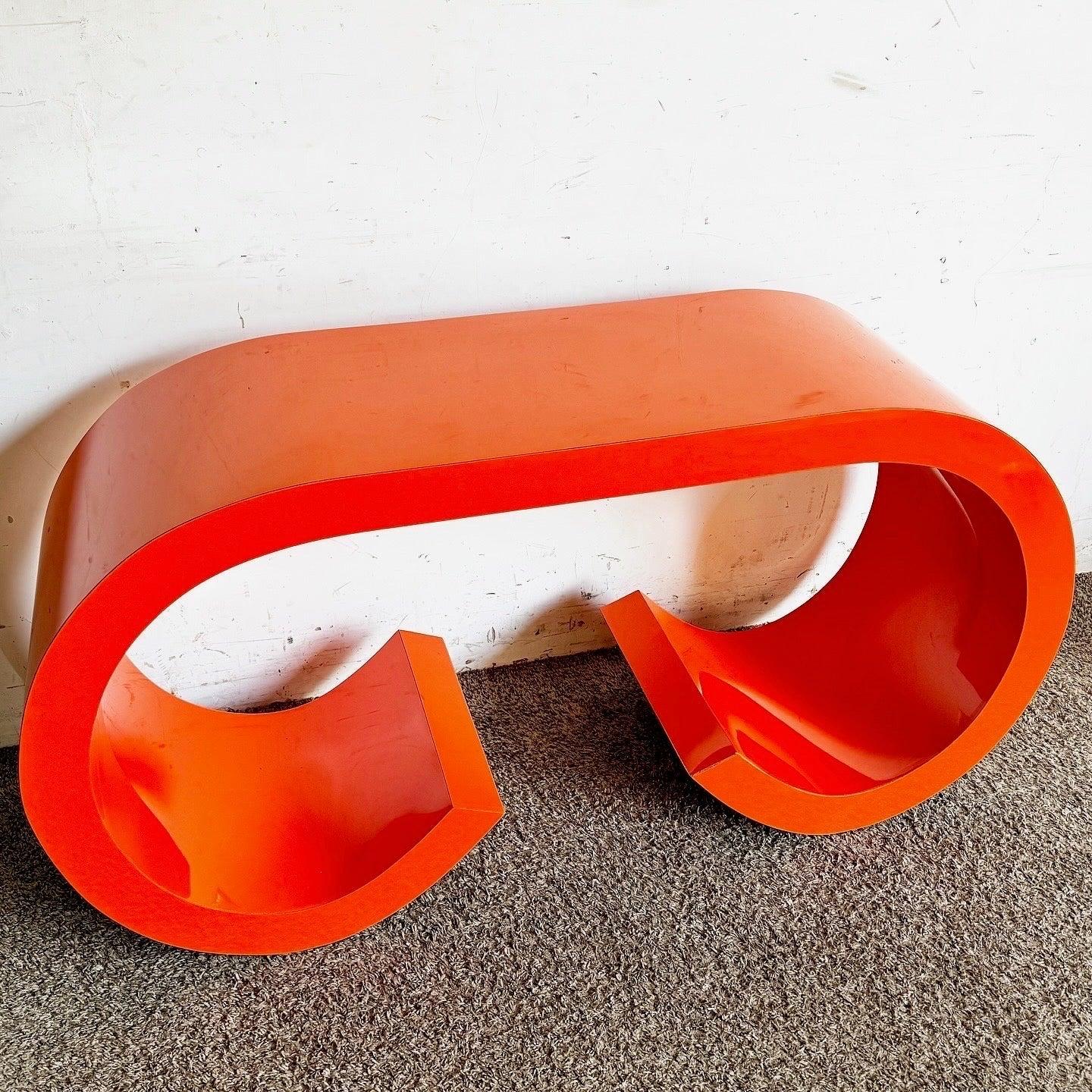 Discover the Postmodern Orange Lacquer Console Table with a scroll waterfall design, epitomizing 1980s aesthetics for your modern home.
 
 We sell items as acquired, without restoring or repairing. Vintage pieces may have age-related wear. Review
