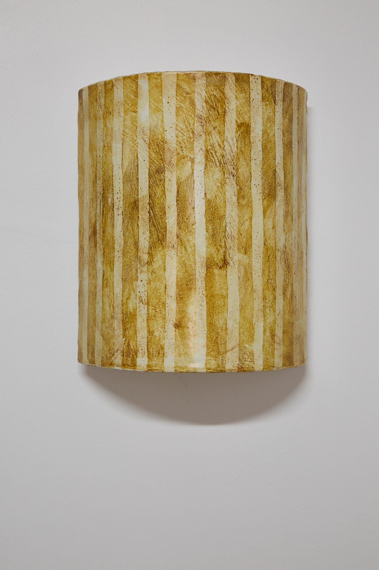 Gently curved ceramic wall sconce cover (no integrated light source) with hand-painted striped finish.