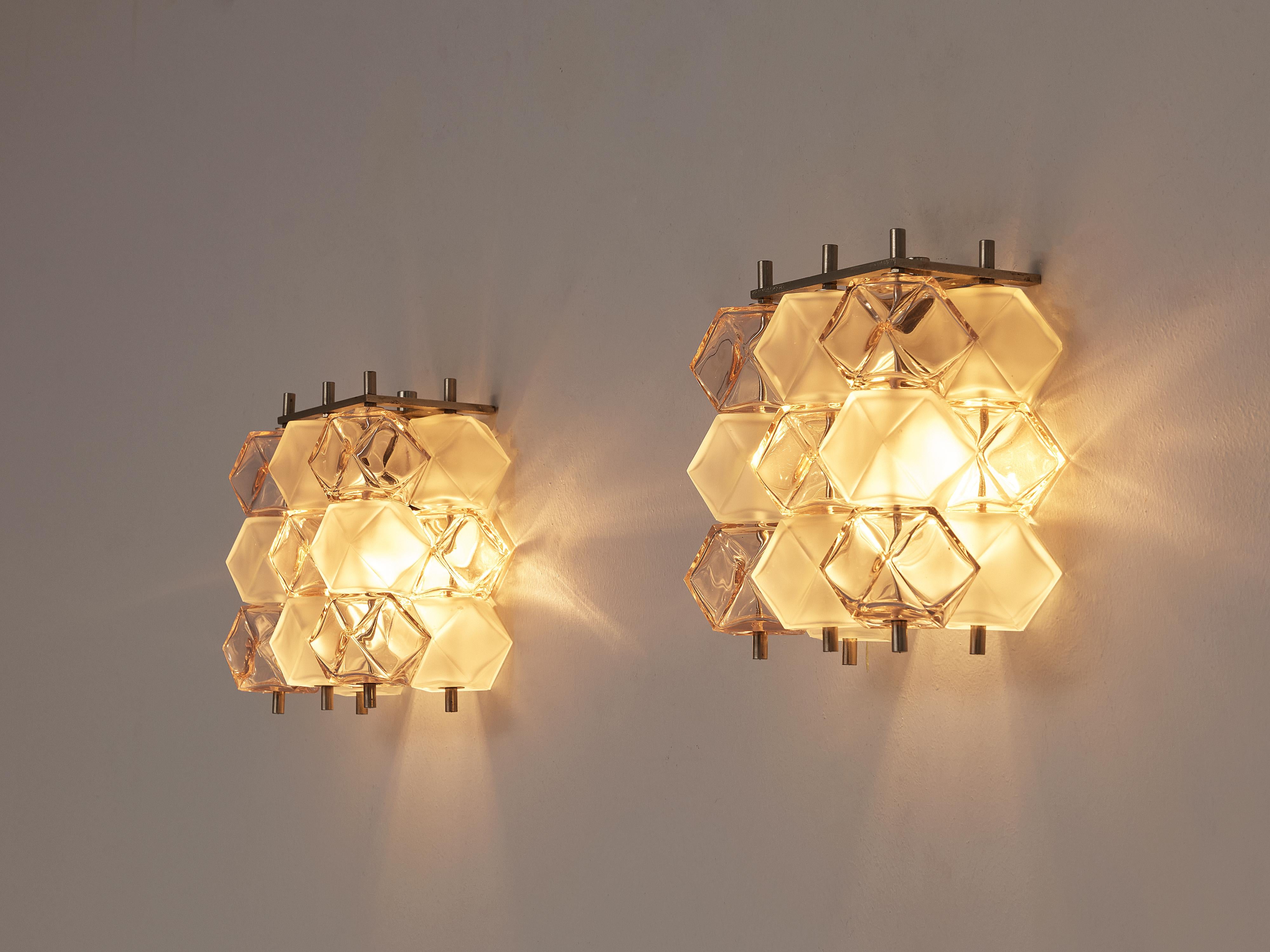 Pair of wall lamps, glass, metal, Europe, 1980s

These lovely wall lights consist of diamond-shaped glass cubes in white and soft pink color. They are adjusted to a metal construction that shows both on top and bottom. Due to the polygonal shape,