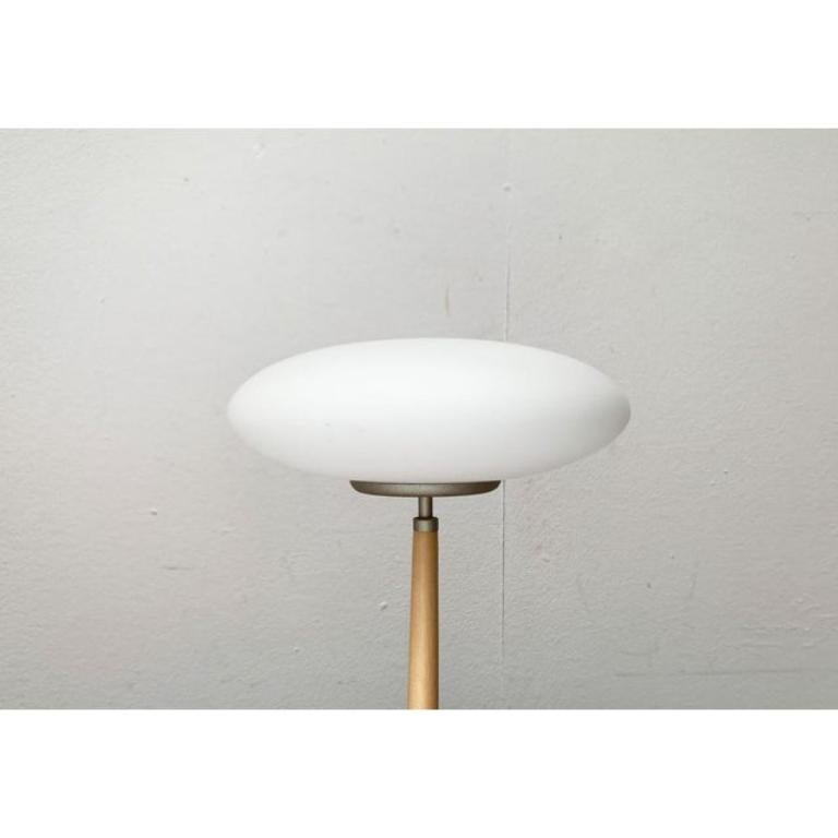 The small T1 table light version from the Pao light series by Matteo Thun. Here in a rare version with a shaft in light beech wood.

The Pao lights impress with their characteristic diffuser and foot made of matt glass. However, the material