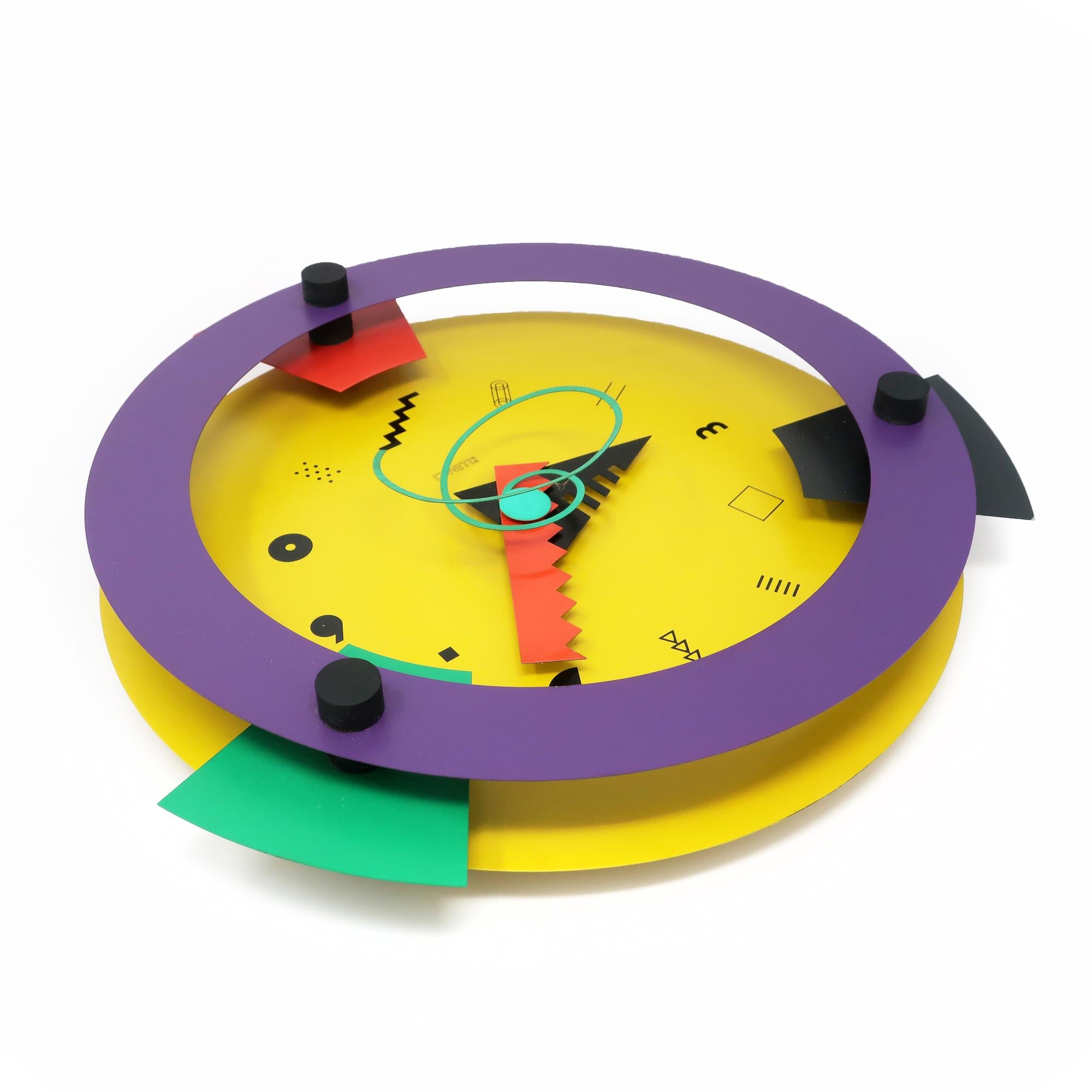 An insanely spectacular postmodern wall clock designed by Shohei Mihara in the 1980s and produced by Wakita and Canetti.  Capturing the best of Memphis Milano's influence on 1980s design, this clock has a round face, geometric accents, a fantastic