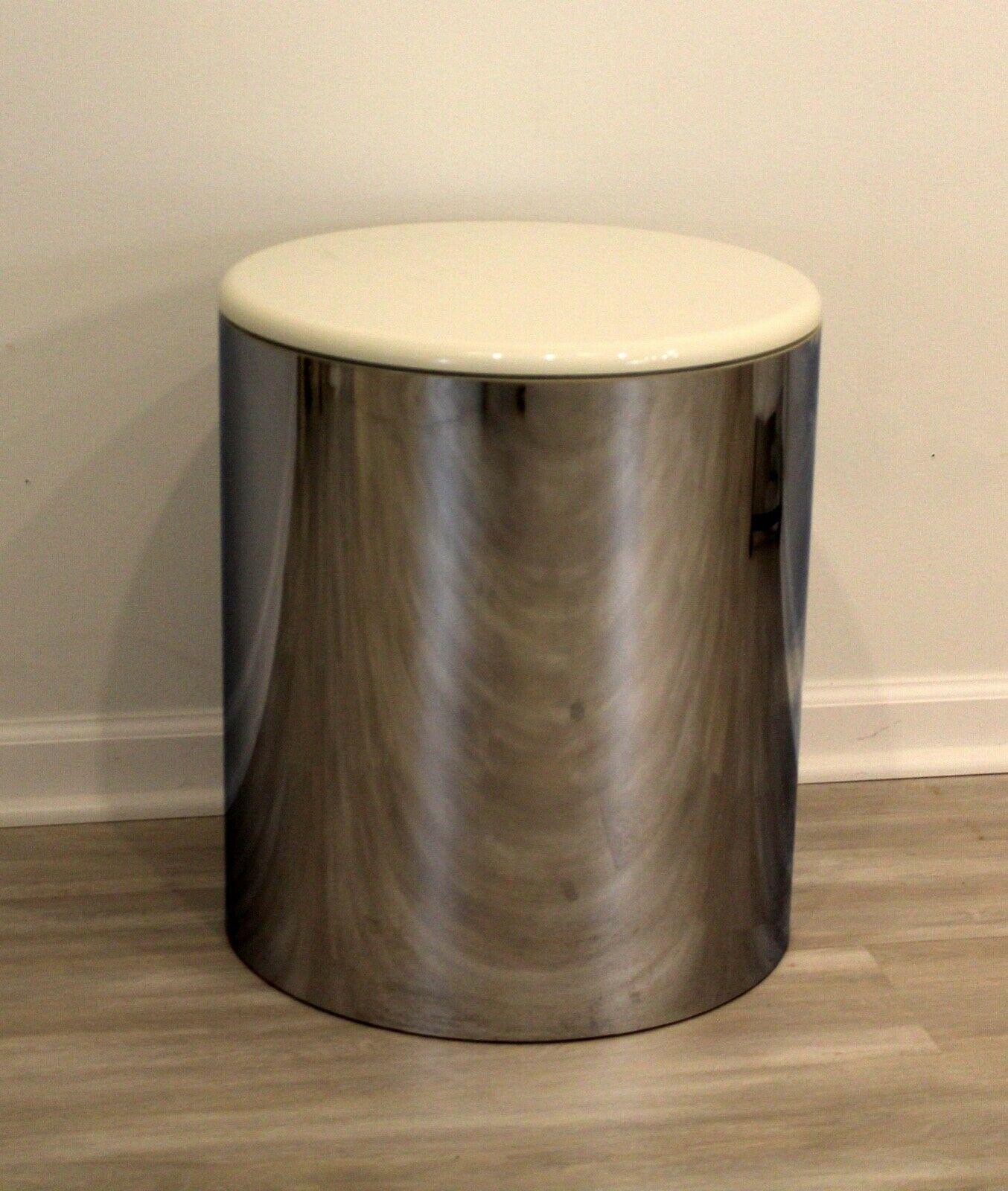 From Le Shoppe Too in Michigan, this sleek Postmodern side table by Paul Mayen has a polished chrome cylindrical base and a modern white lacquered top. Neutral enough to work with most modern interiors and sculptural enough as a stand alone piece.