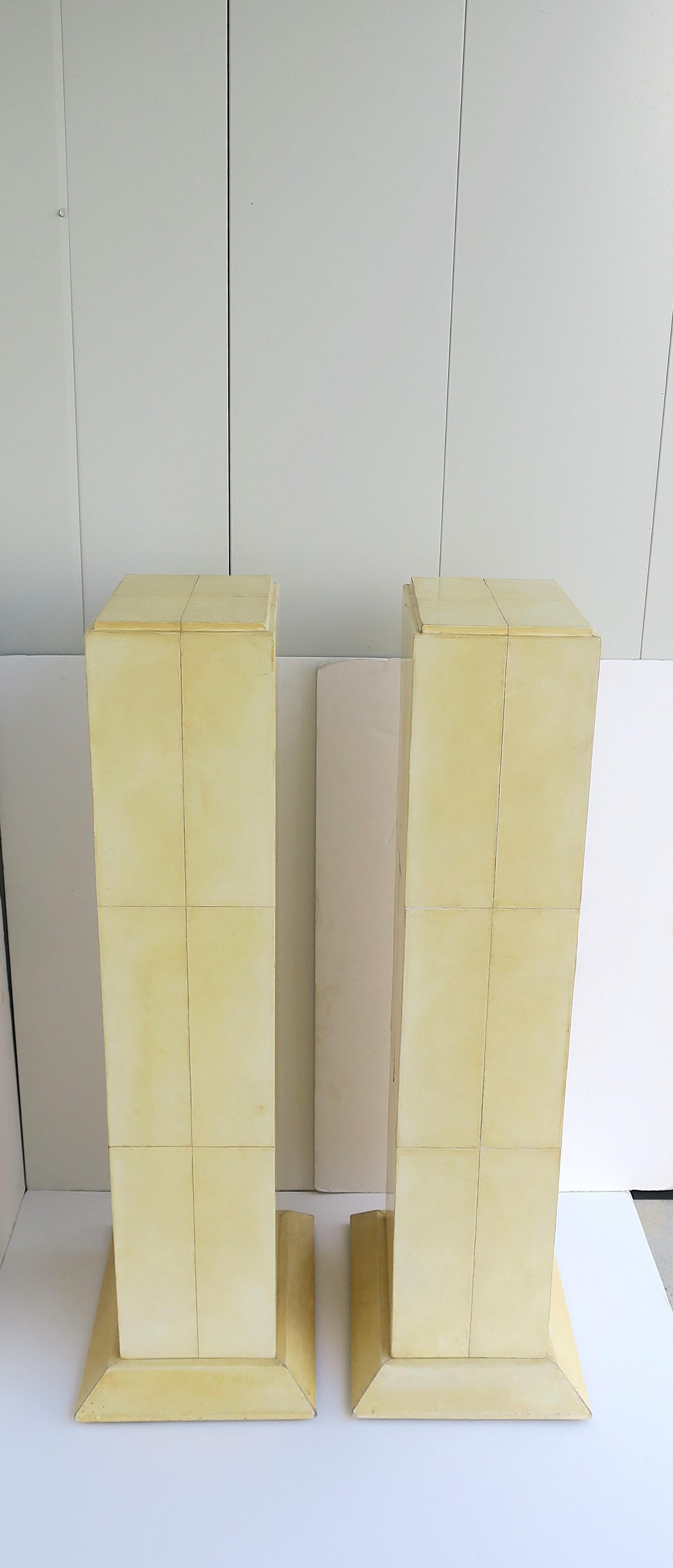 A pair of goatskin pedestals columns, Postmodern design period, in the style of designer Karl Springer, circa late-20th century. Exact origin is unknown; set may be European. Pedestal/columns are rectangular in shape with rectangular goatskin