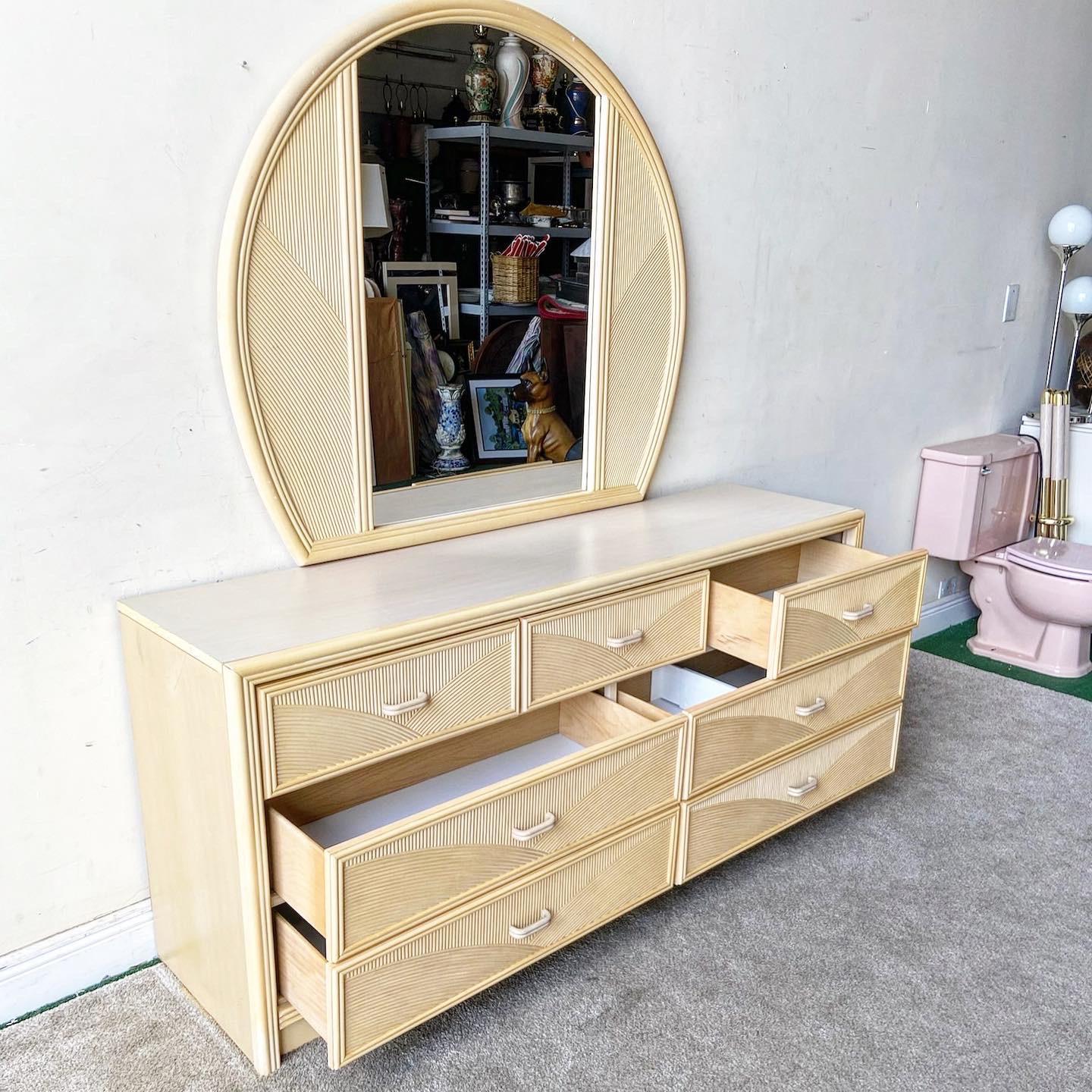 Exceptional boho 7 drawer dresser by Lea Furniture. Each drawer face features a wavy pencil reed.

Mirror measures 50”W, 1.25”D, 43.5”H.