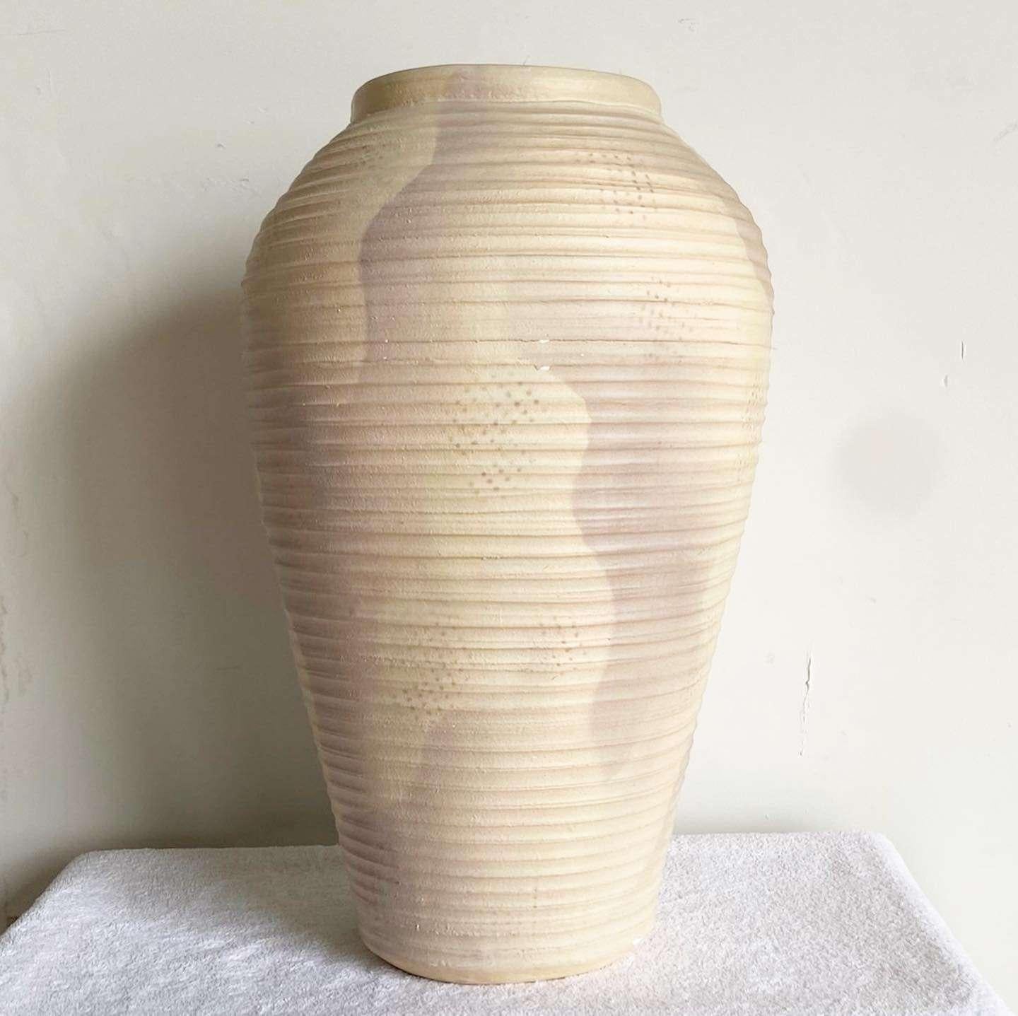Exceptional vintage postmodern ribbed ceramic floor vase. Features a beige finish with a purple brushed accent.

