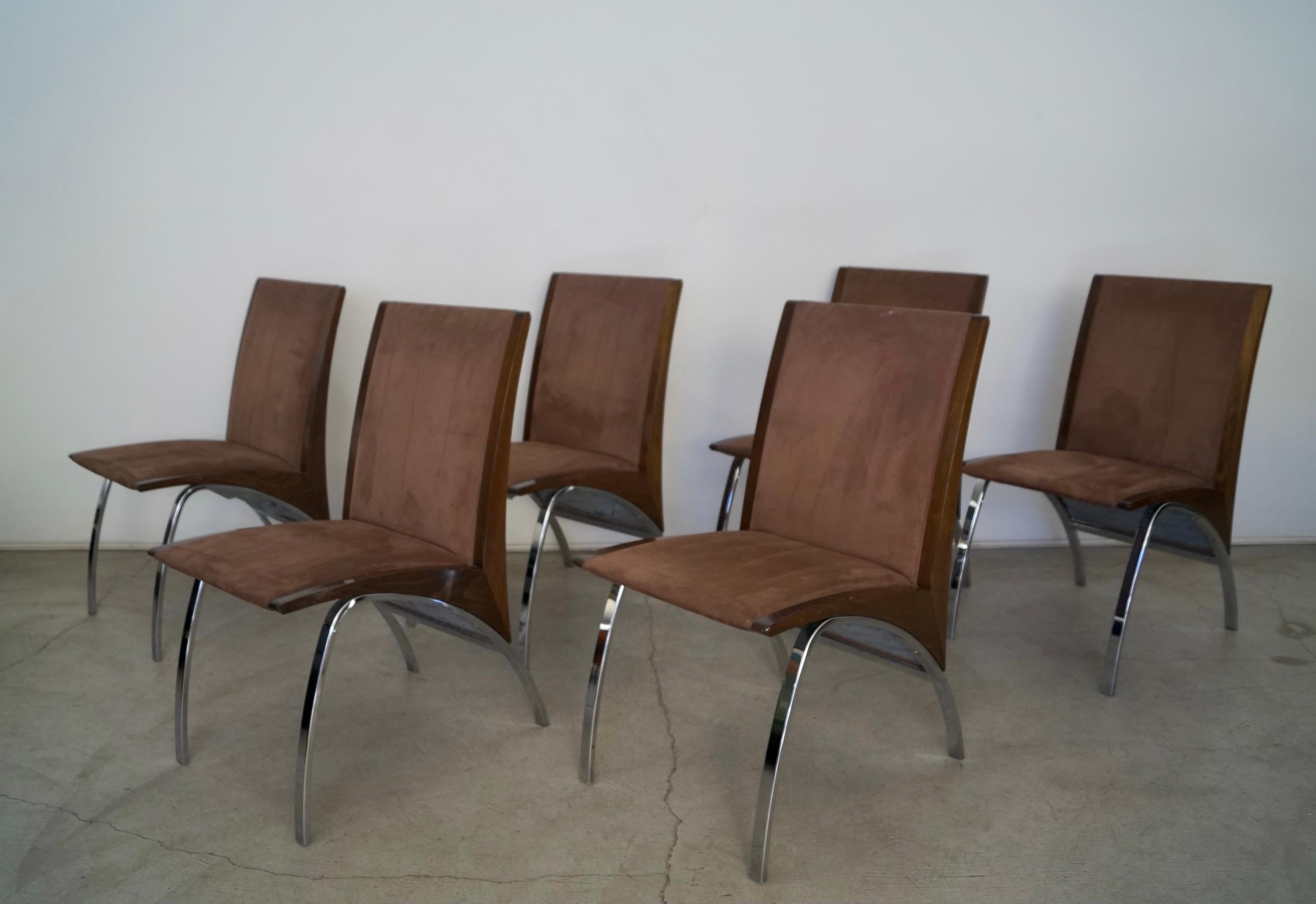 Incredible post-modern dining chairs for sale. From the late 1990's / early 2000's, and truly unique. They were designed by Pietro Costantini, and manufactured by Ello Furniture which is now defunct. They have a an arching chrome base with a