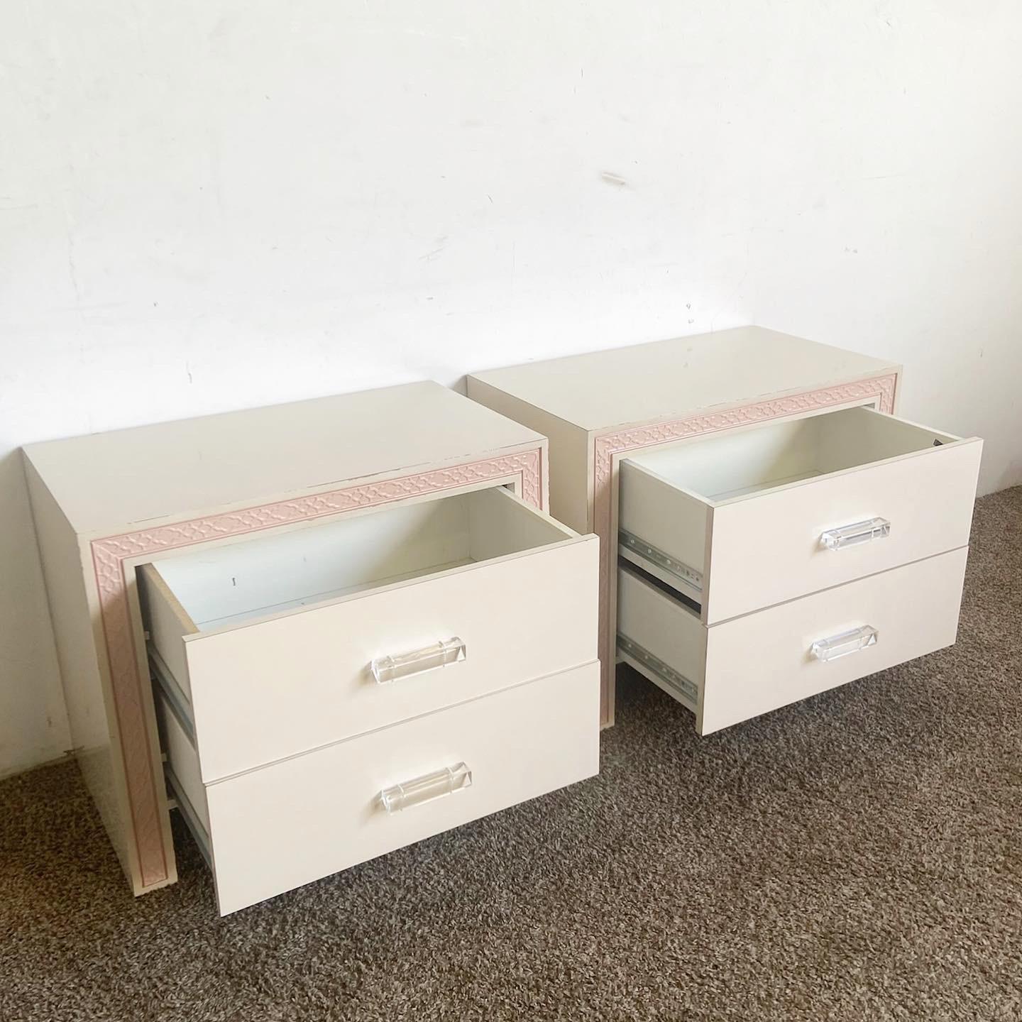Elevate your bedroom with these Pink Postmodern Nightstands with Lucite handles. A pair, they blend soft pink bodies with crisp white drawer fronts, embodying postmodern charm. The transparent lucite handles introduce a touch of luxury, making these
