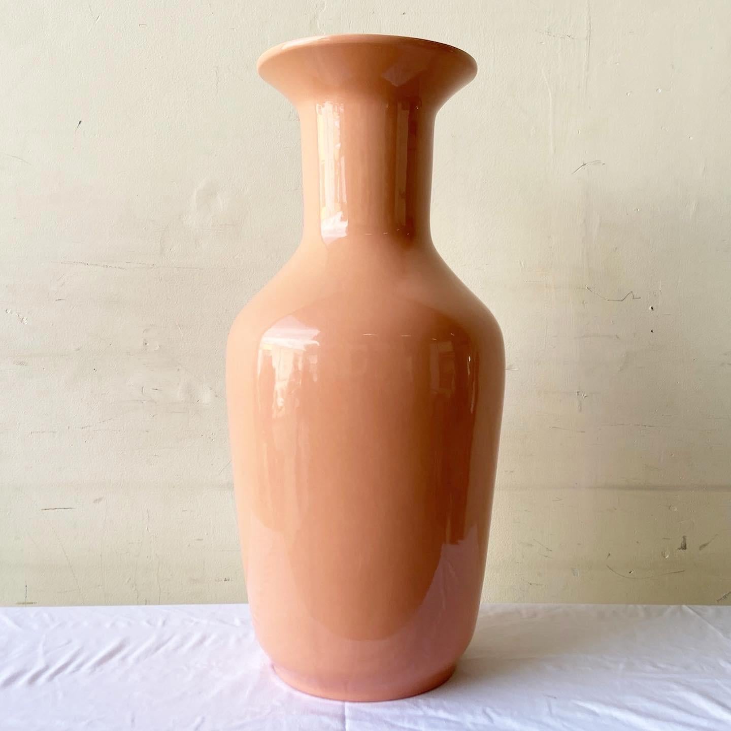 Incredible postmodern ceramic floor vase. Features a glossy peachy pink finish.

Additional Information:
Material: Ceramic
Color: Pink
Style: Postmodern
Time Period: 1980s
Place of origin: USA
Dimension: 11