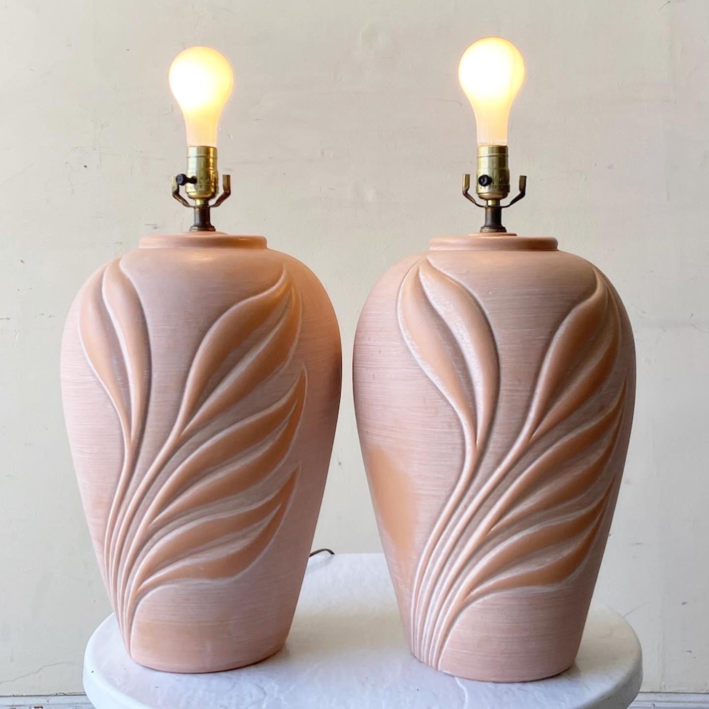 Awesome pair of postmodern ceramic table lamps by Harris Lamps. Each lamp displays a pink embossed bouquet.
   