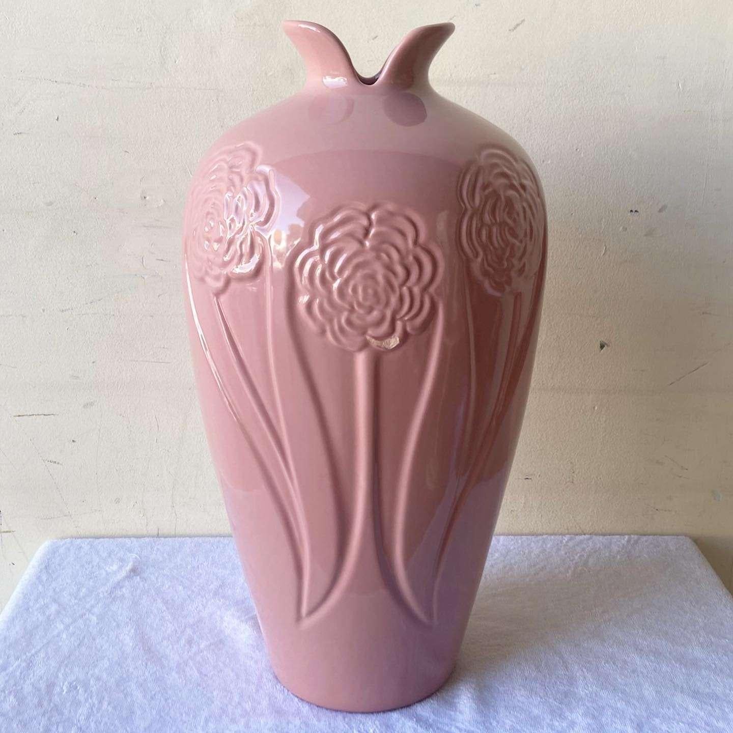 Exceptional vintage Postmodern ceramic floor vase. Features a glossy pink finish with flowers etched around the bust and base.

