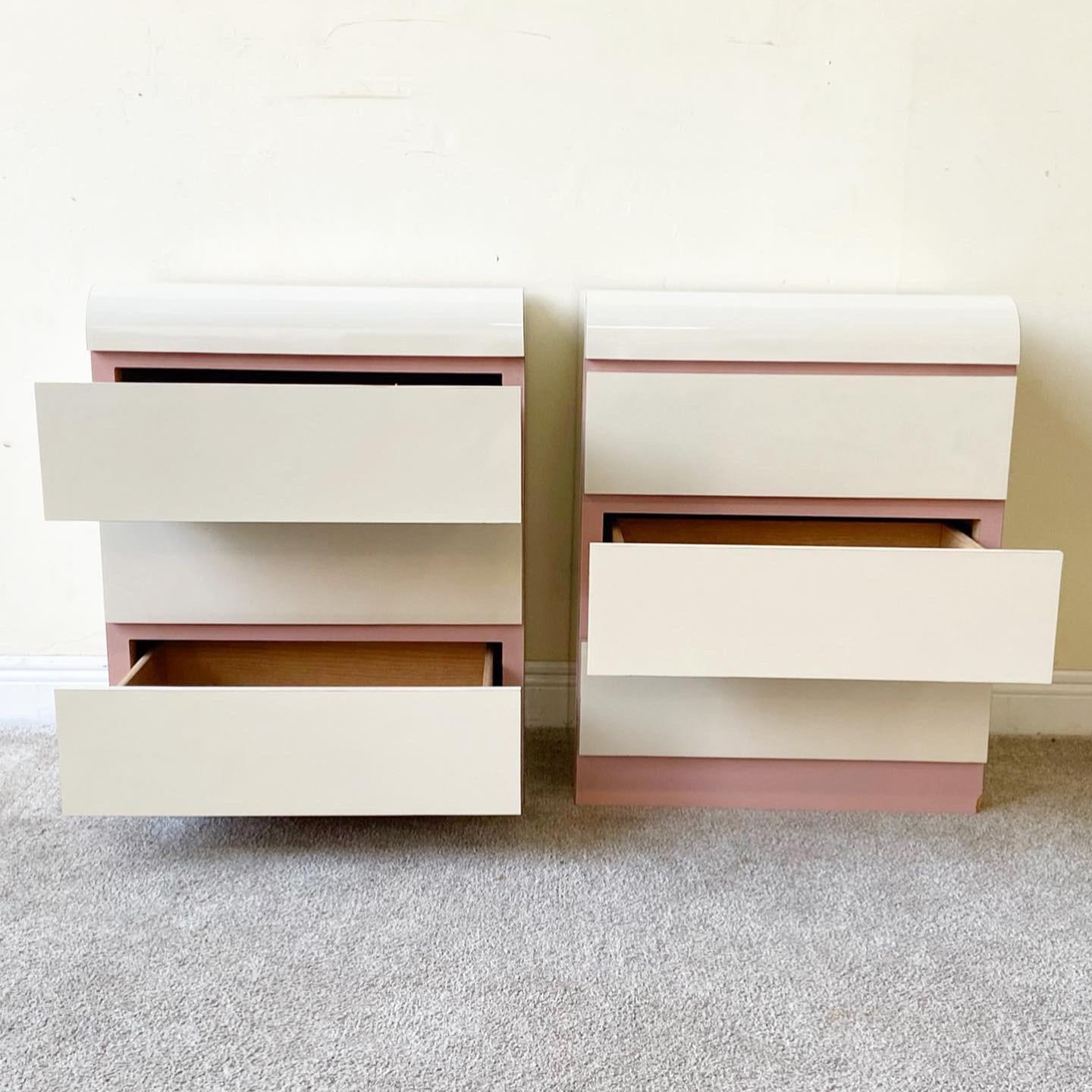 Amazing pair of waterfall nightstands with a cream and pink lacquer laminate. Each nightstand features 3 spacious drawers.
 
