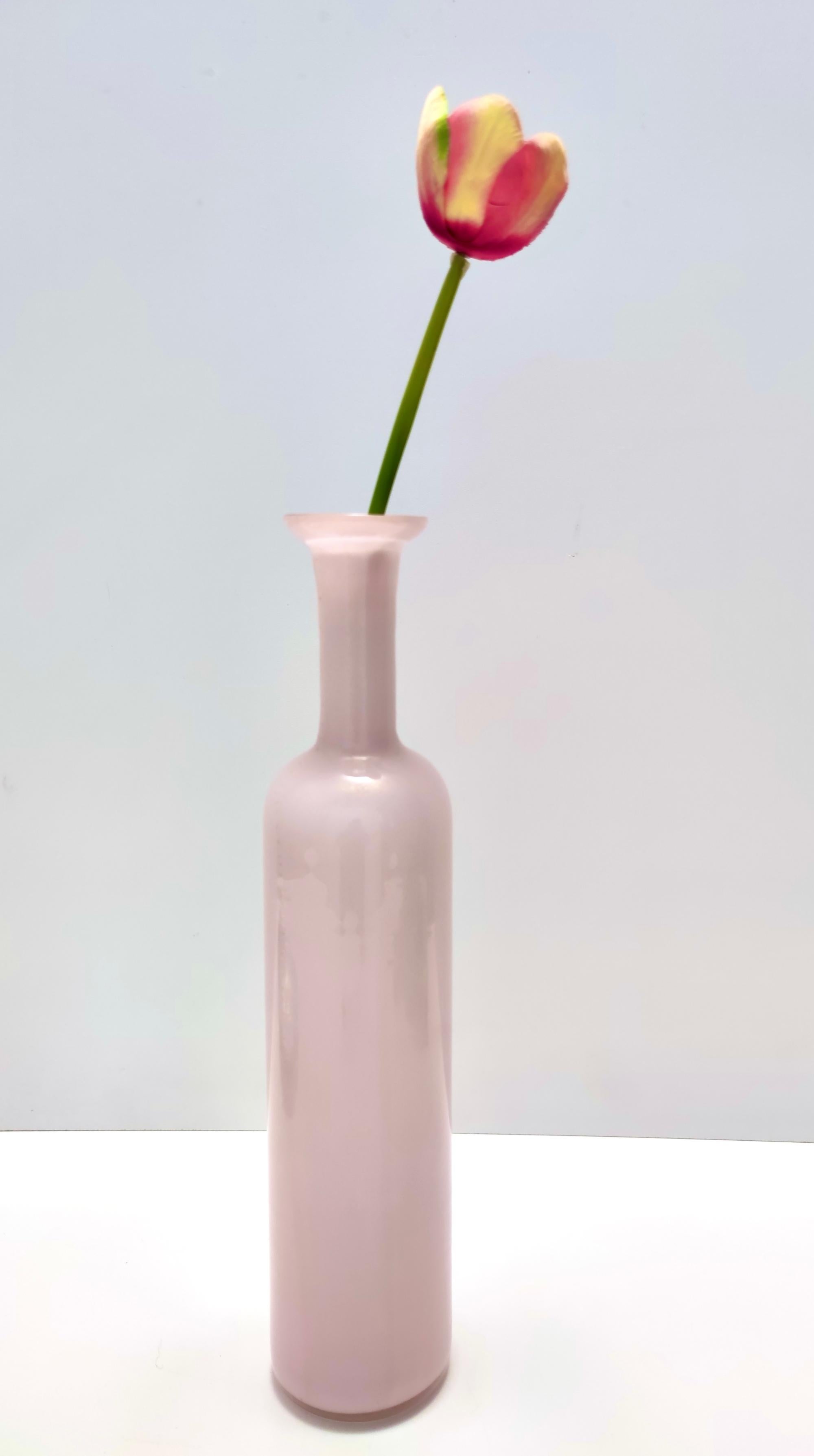 Fabriqué en Italie, années 1970. 
Ce magnifique vase/bouteille est réalisé en verre de Murano enchâssé de rose et de feuilles d'or.
Il s'agit d'une pièce vintage, elle peut donc présenter de légères traces d'utilisation, mais elle peut être
