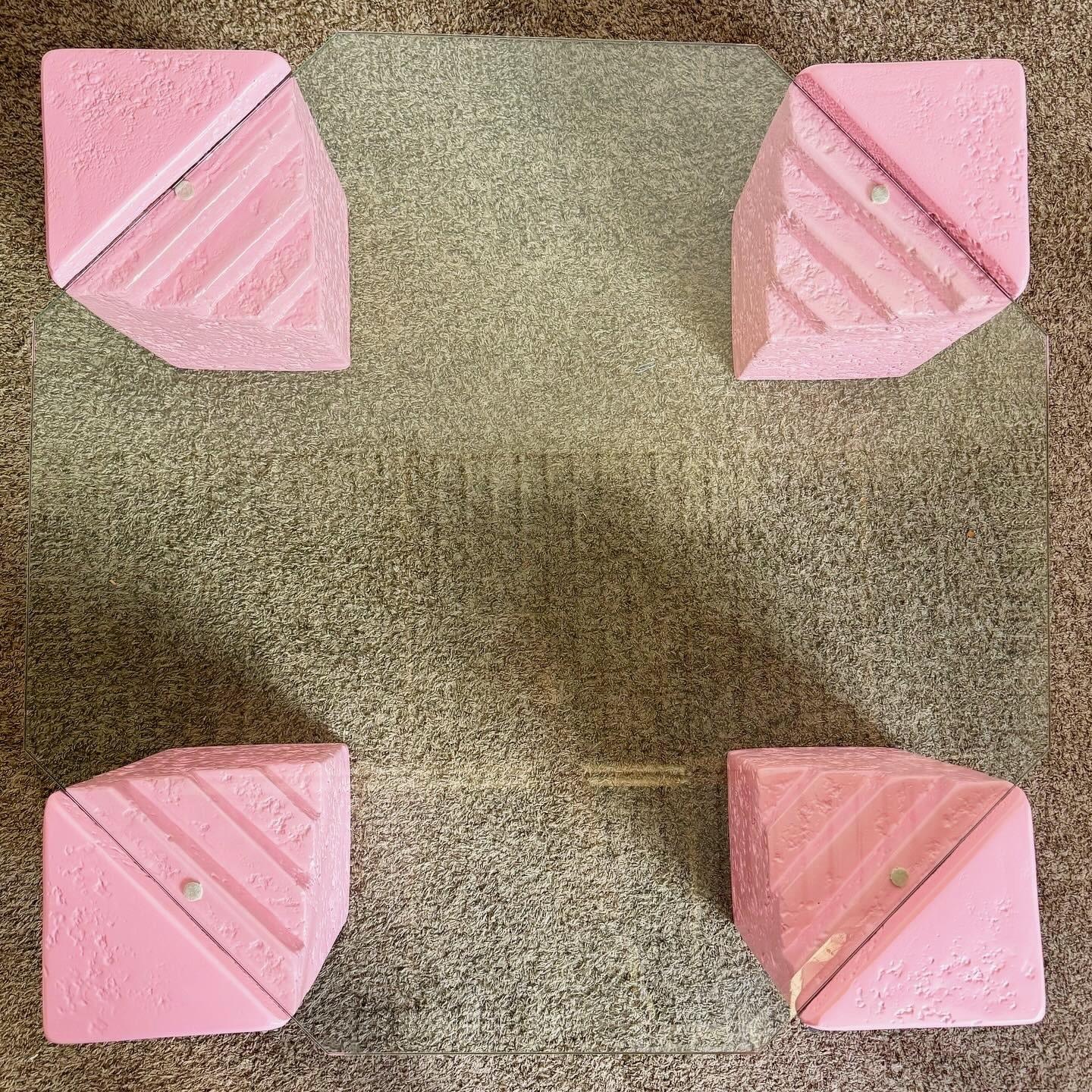 Introduisez une touche d'élégance d'inspiration marine dans votre espace de vie avec cette table basse octogonale postmoderne en plâtre de faux corail rose. Avec son plateau octogonal en verre biseauté incrusté dans quatre coins en plâtre de texture