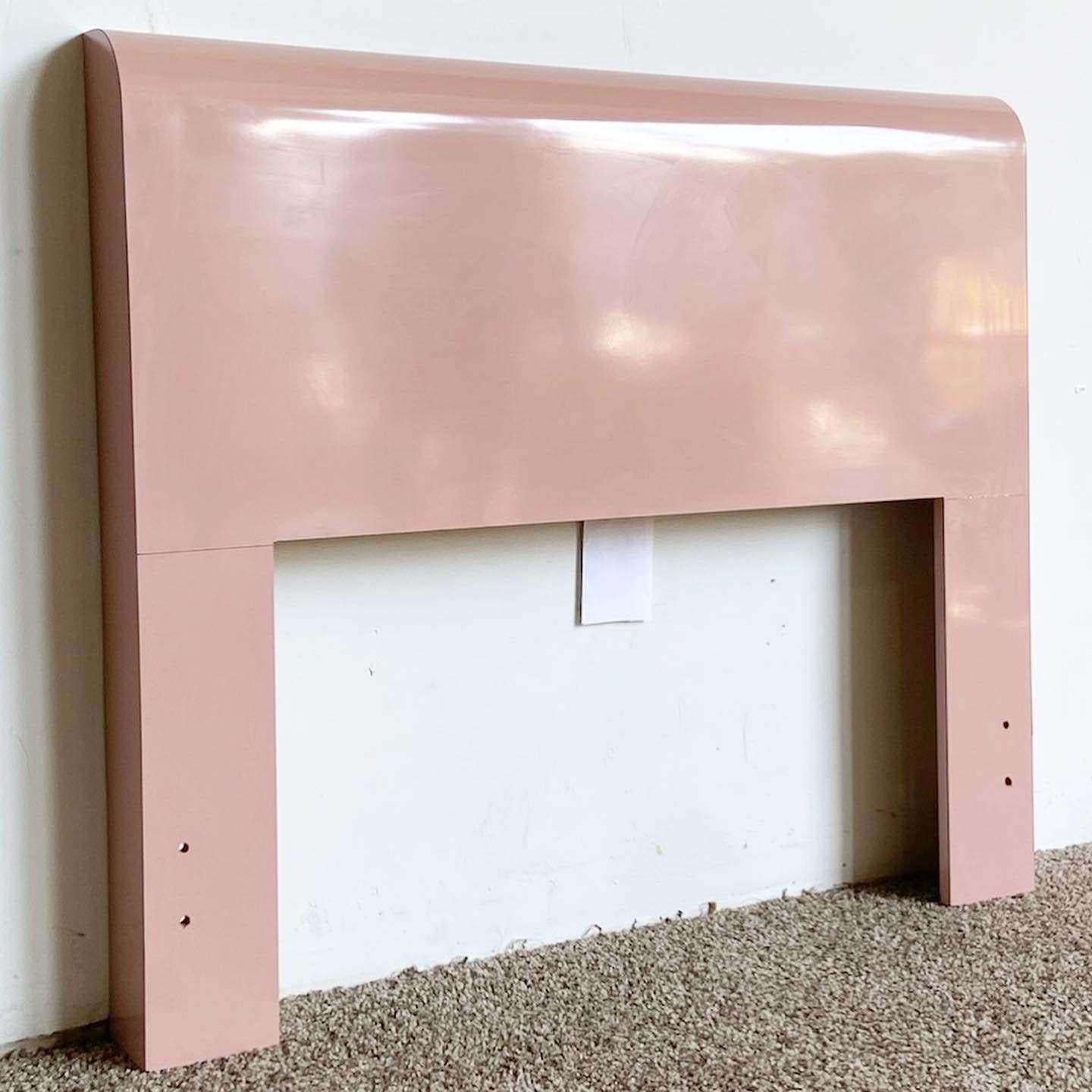 Exceptional vintage postmodern twin size waterfall headboard. Features a pink lacquer laminate.
