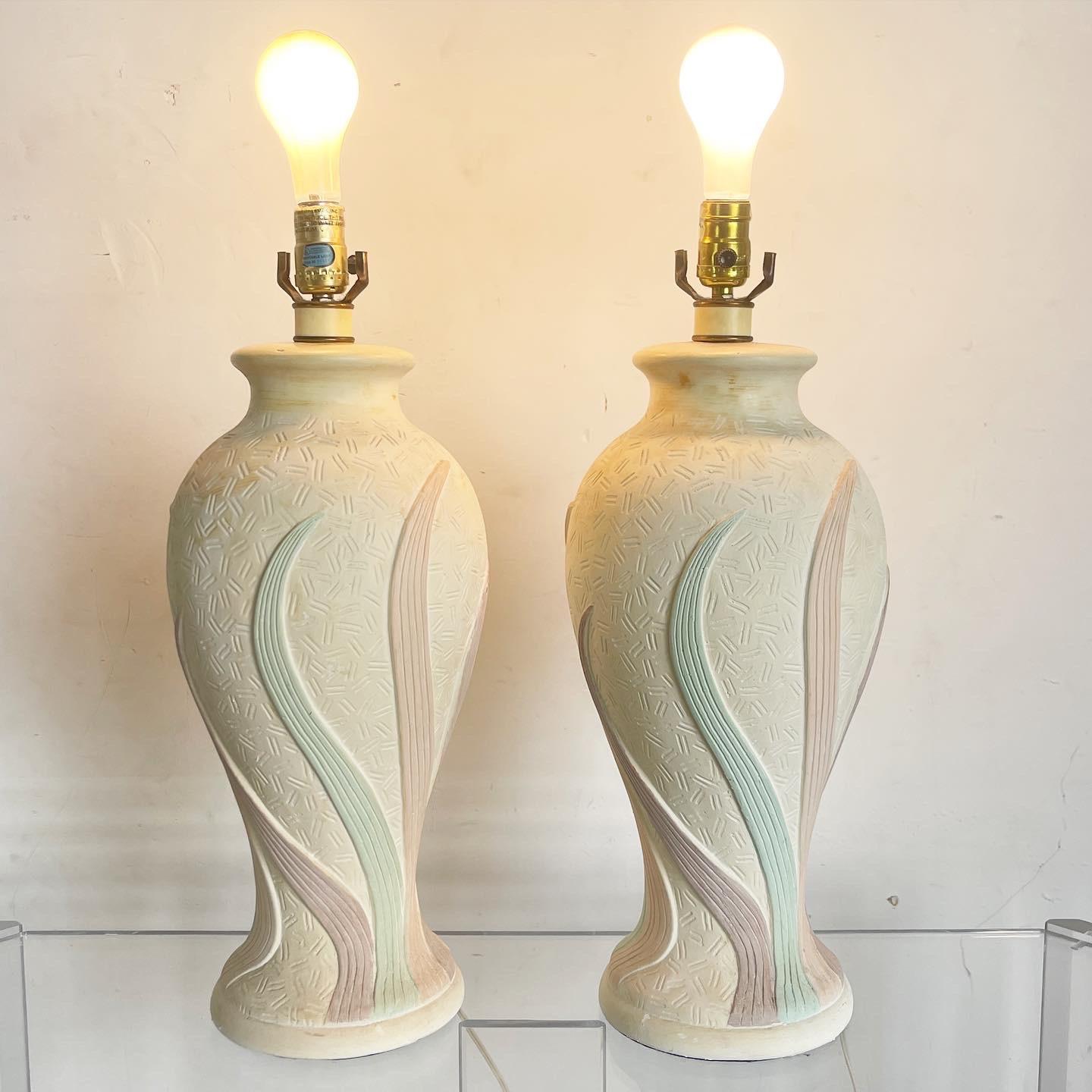 Experience vibrant style with the Pink Green Purple Swirl Table Lamps, a postmodern pair featuring two-tiered ceramic sections adorned with swirling colors. These eye-catching lamps infuse spaces with artistic flair, reflecting bold aesthetics,