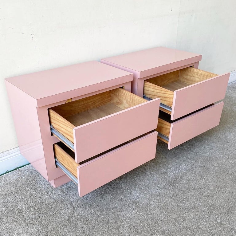 Excellent pair of 1980s postmodern nightstands. Each features a pink lacquer laminate with 2 spacious drawers.
 