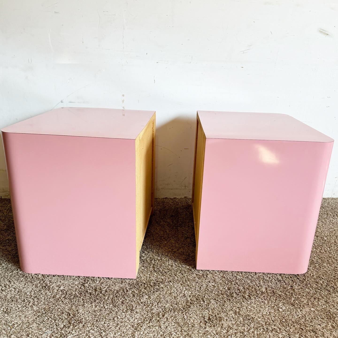 Add a splash of modernity to your bedroom with these Postmodern Pink Lacquer Laminate Nightstands with Chrome Handles. The bold pink hue and sleek chrome handles create a striking contrast, offering a playful yet sophisticated look. Equipped with