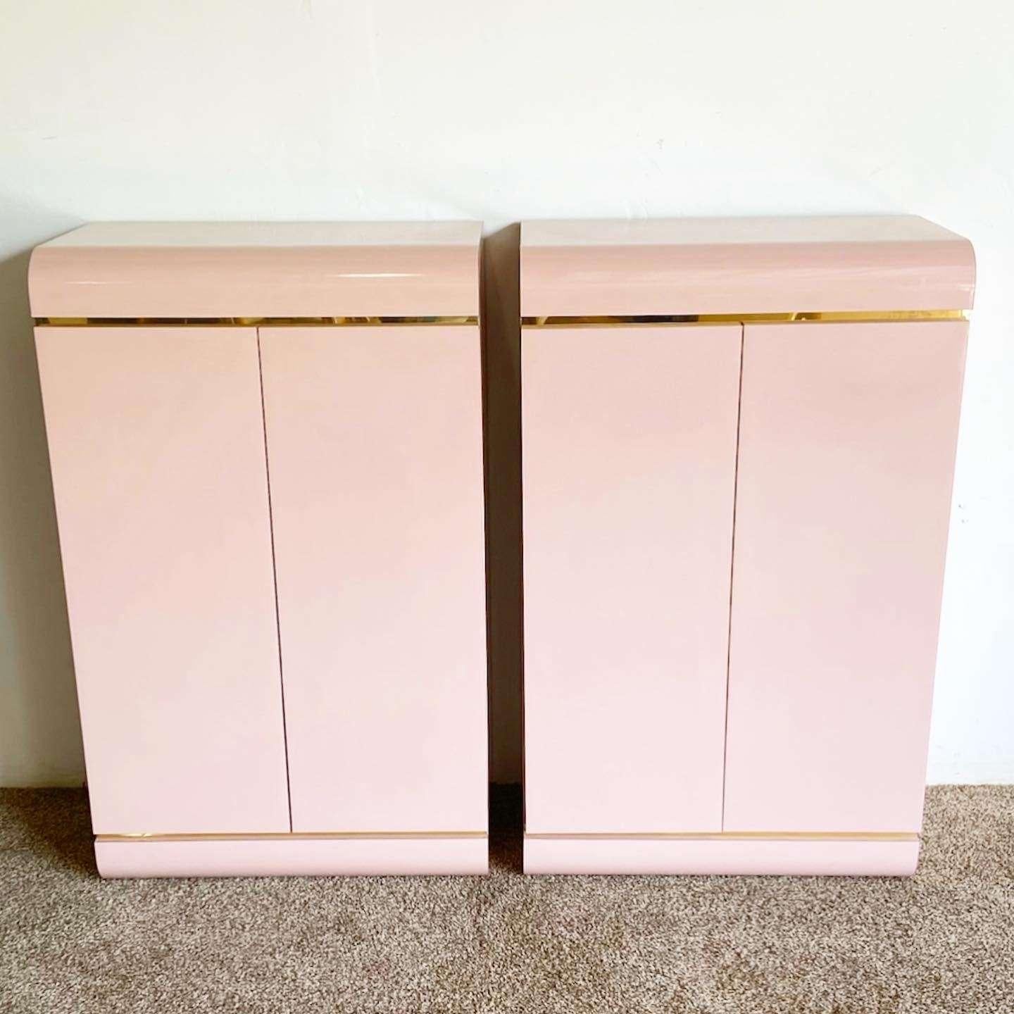 Amazing vintage postmodern pair of waterfall cabinets. Each feature a pink lacquer laminate with gold accent.
