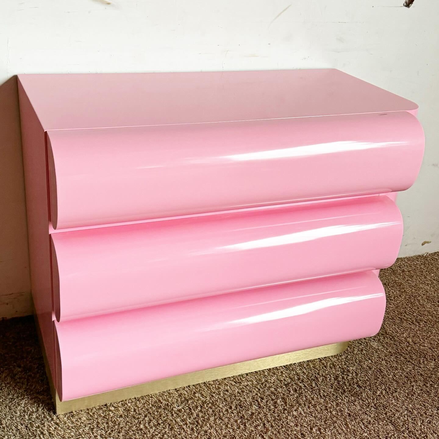 Embrace a bold and sophisticated aesthetic with this Postmodern Pink Lacquered Curved Bullnose Commode/Chest of Drawers, featuring elegant gold accents. This striking piece showcases a unique curved bullnose design, coated in a vivid pink lacquer