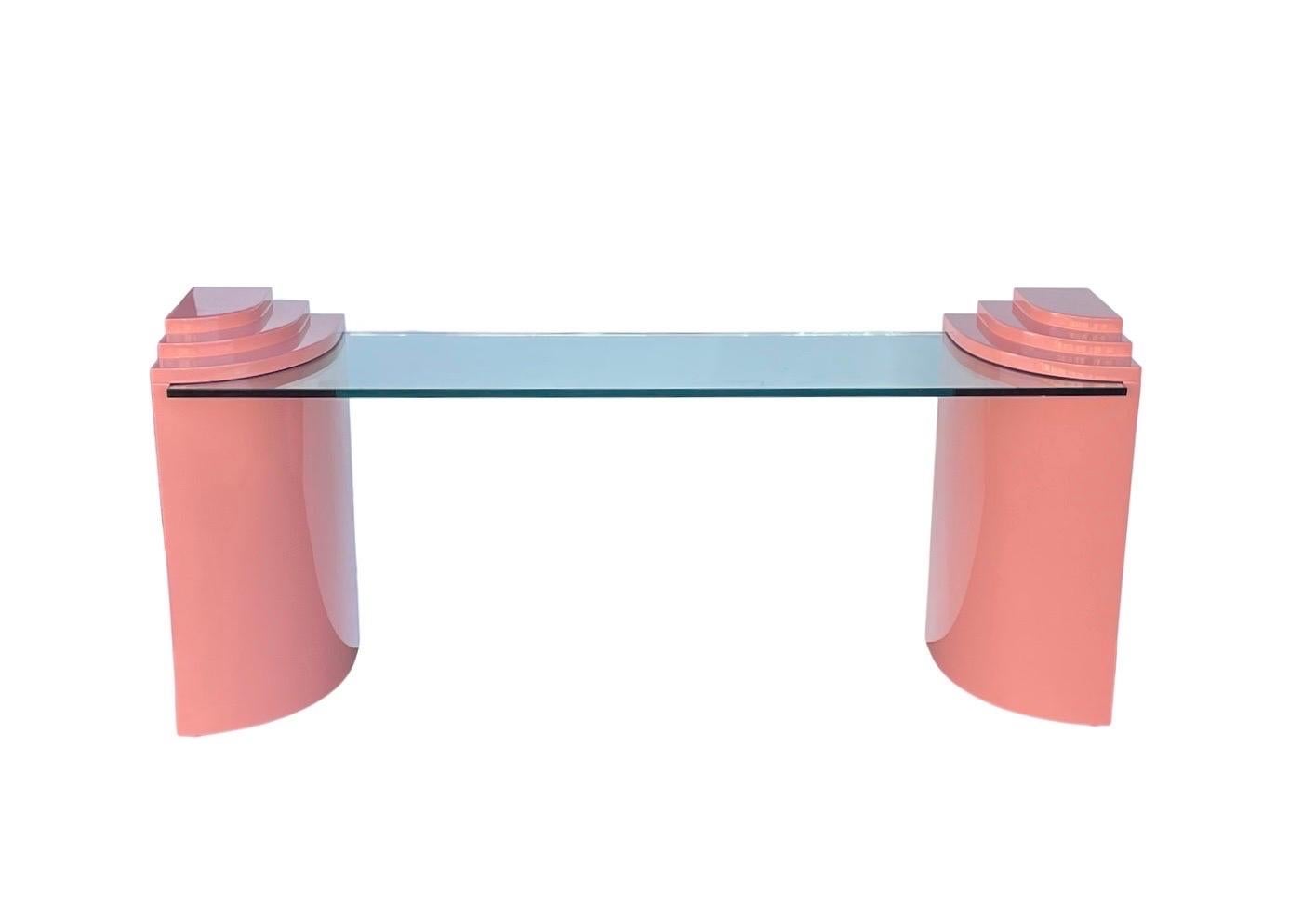 Stunning three piece console table with pink tiered lacquered columns and a 3/4” thick glass top.