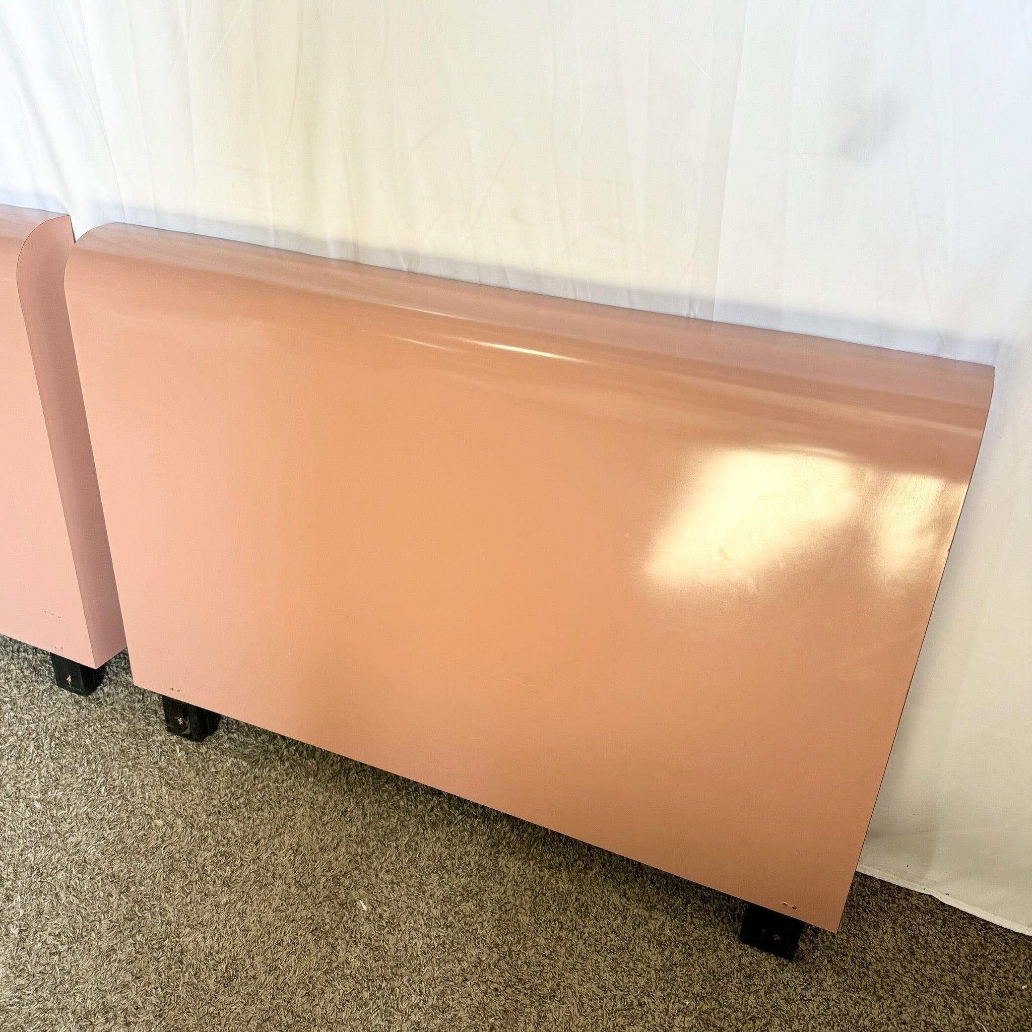 Pair of Postmodern pink laminate twin waterfall headboards featuring a sleek design and vibrant finish, perfect for adding a bold touch to any bedroom.
 
 We sell items as acquired, without restoring or repairing. Vintage pieces may have age-related