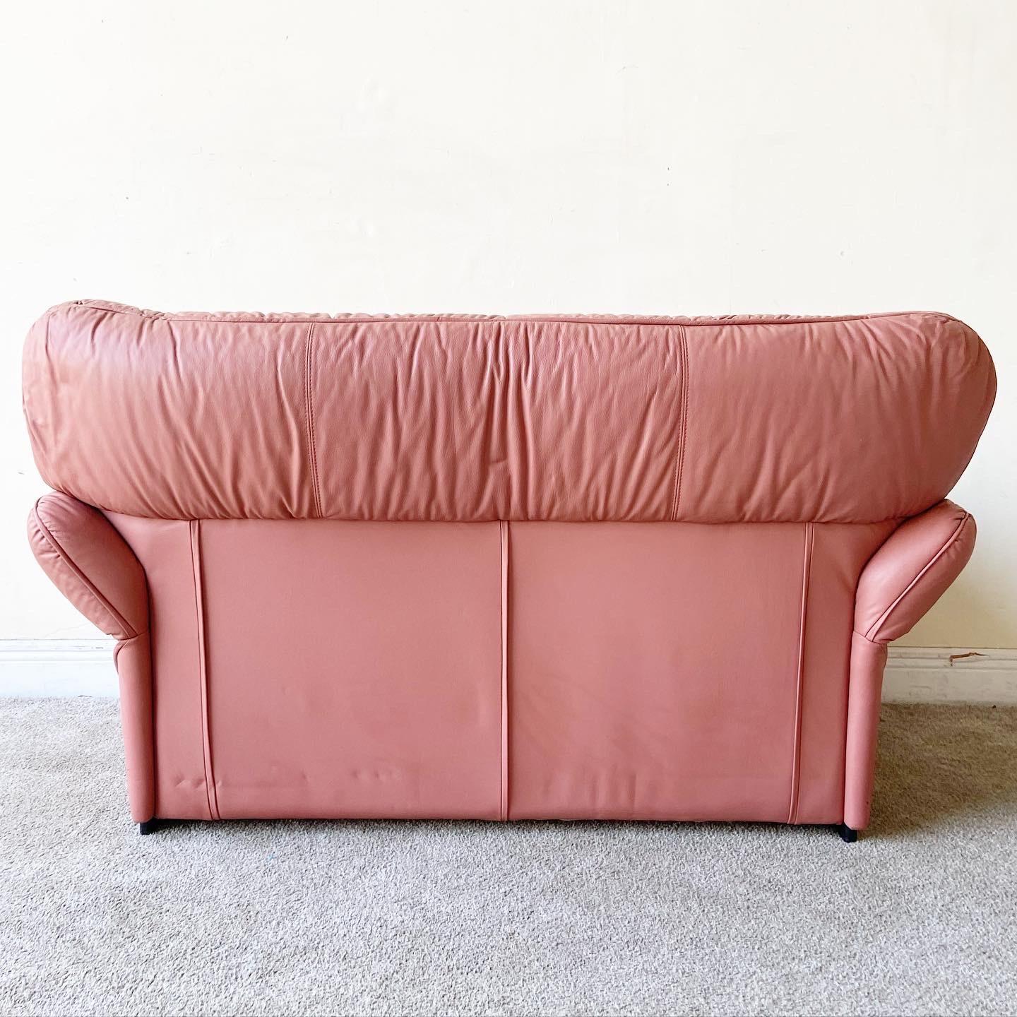Incredible postmodern two seater love seat sofa by Pro-Design. Features a pink leatherette.
 