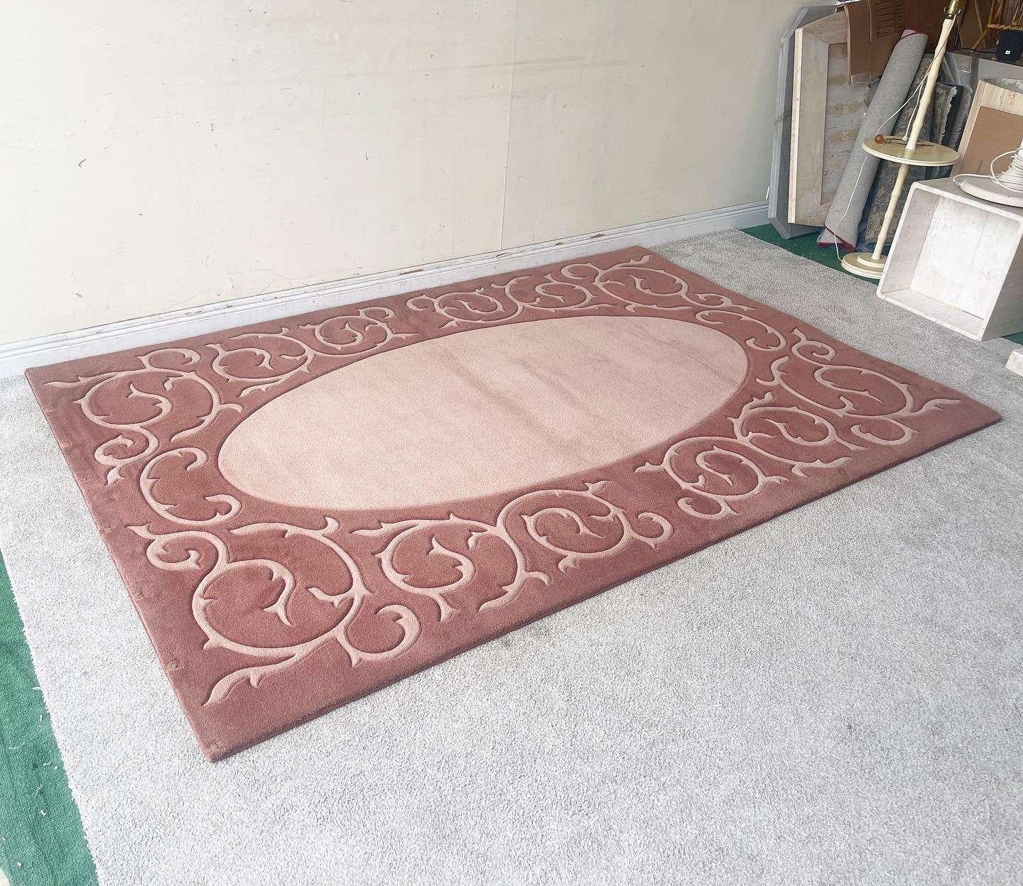 Exceptional vintage postmodern rectangular area rug. Features a light pink oval interior bordered by a dark pink section with light pink vining throughout.

Rug 21
