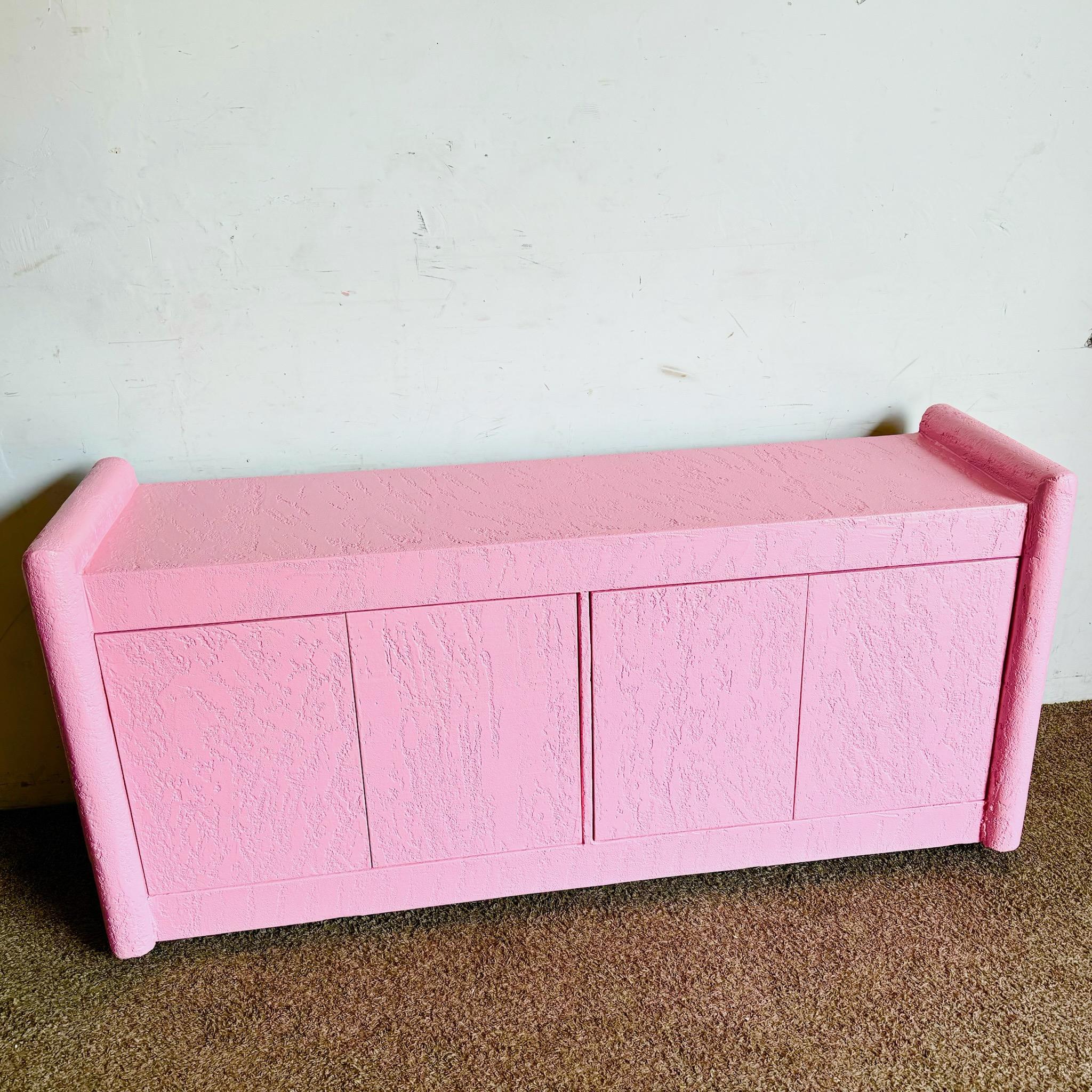 Fai una dichiarazione audace con questa credenza postmoderna con finitura a stucco rosa. Questo pezzo accattivante è caratterizzato da un'esclusiva texture a stucco e da una sorprendente tonalità rosa, che fonde perfettamente forma e funzione.