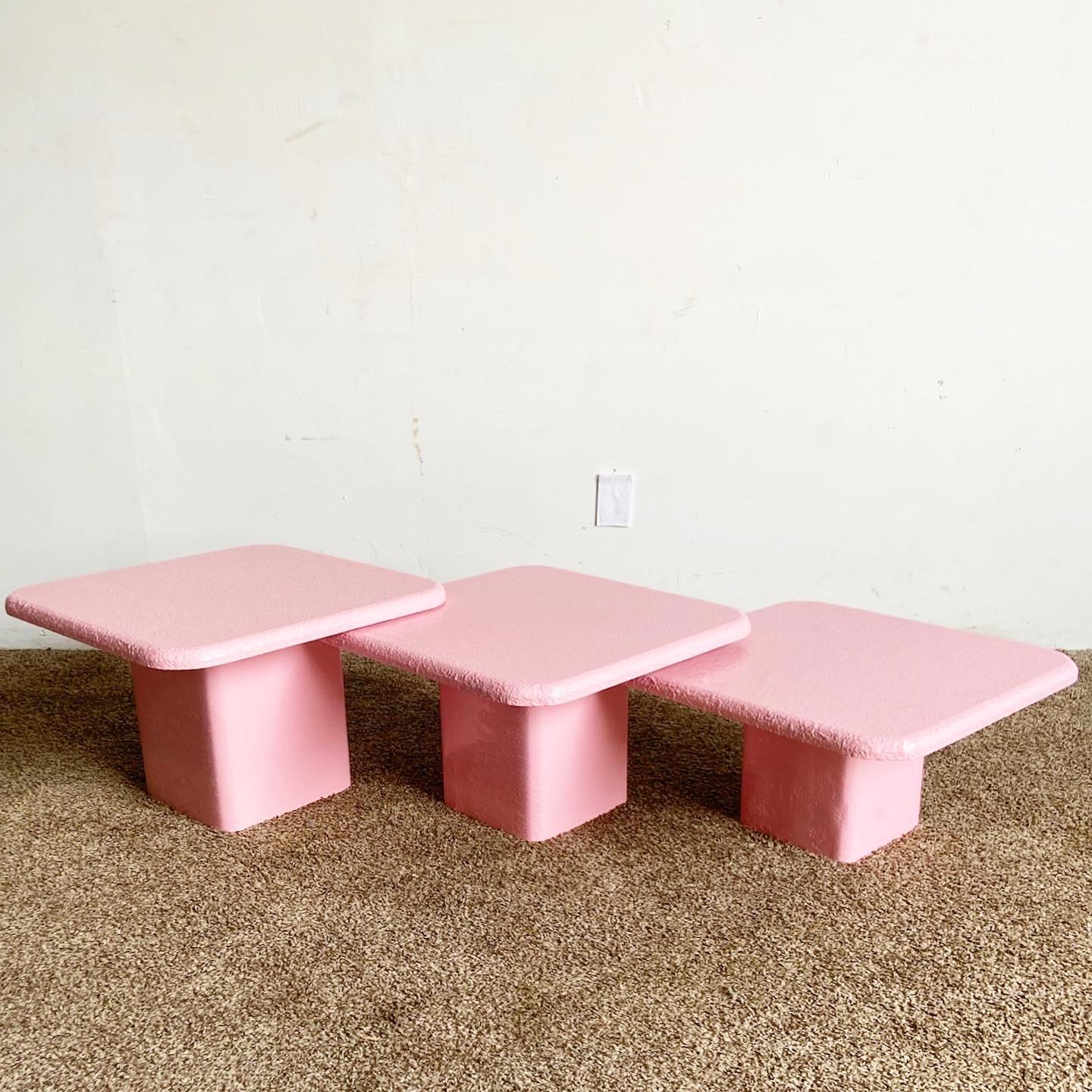Embark on a whimsical journey through design with our captivating Postmodern Pink Textured Nesting Square Mushroom Tables. This enchanting three-piece set seamlessly combines playful aesthetics with practical functionality, bringing a sense of joy