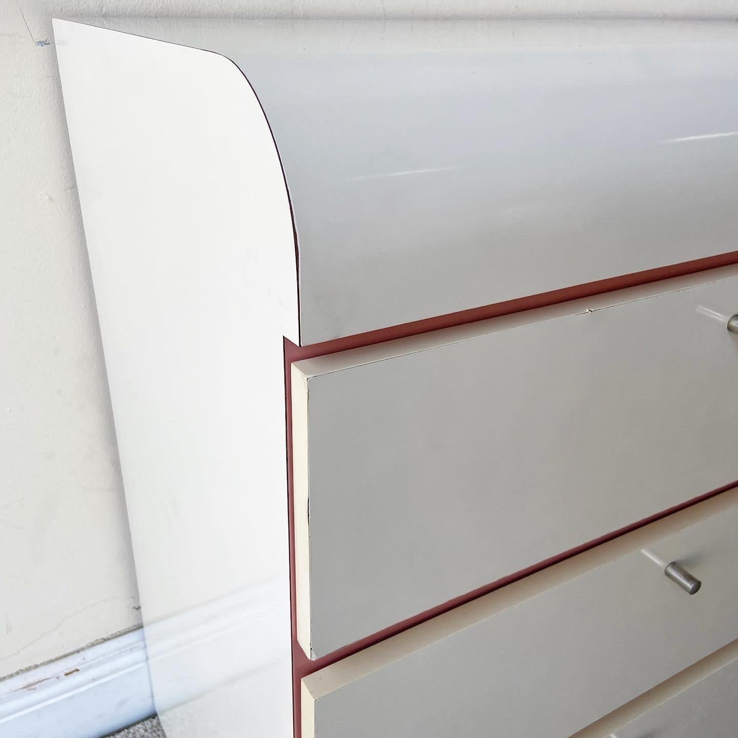 Amazing postmodern 1980s waterfall lowboy dresser. Features a white and pink lacquer laminate.
 