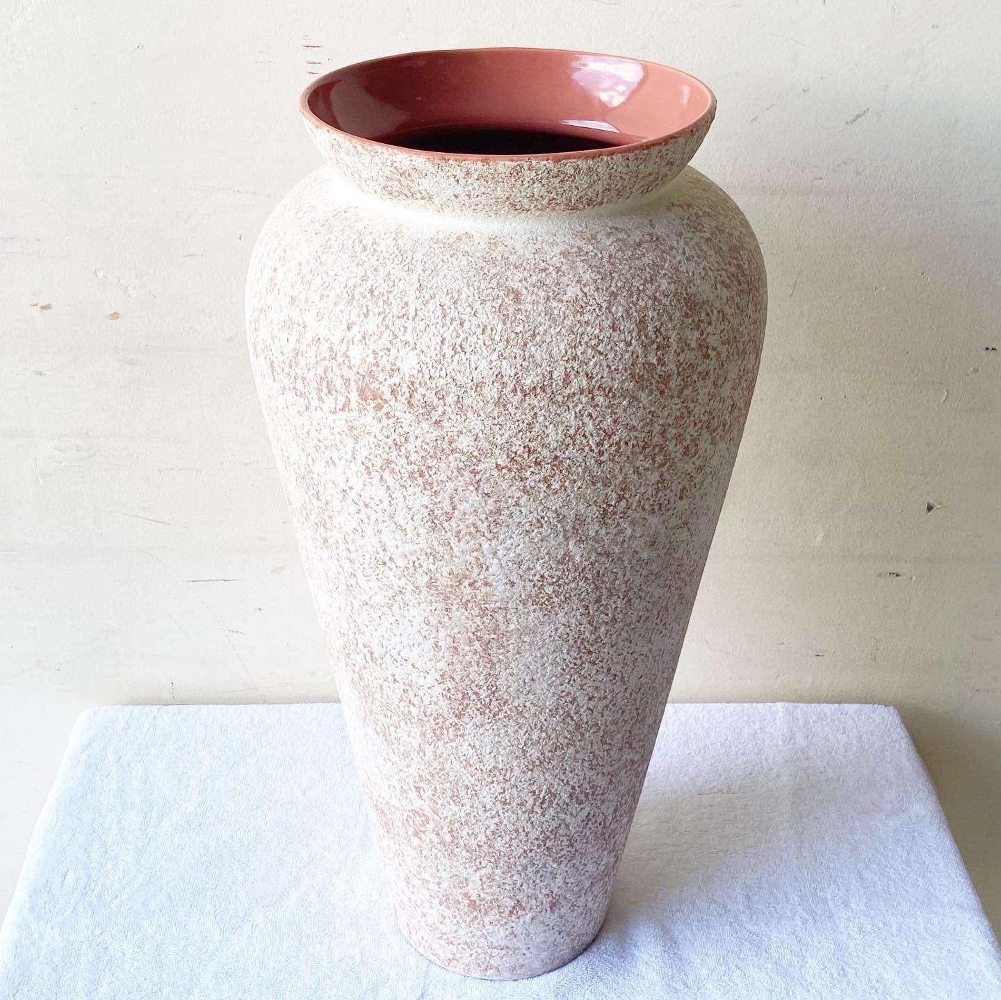 Exceptional vintage postmodern ceramic floor vase by Haeger. Features a link gloss finished with a rough white speckled finish.
