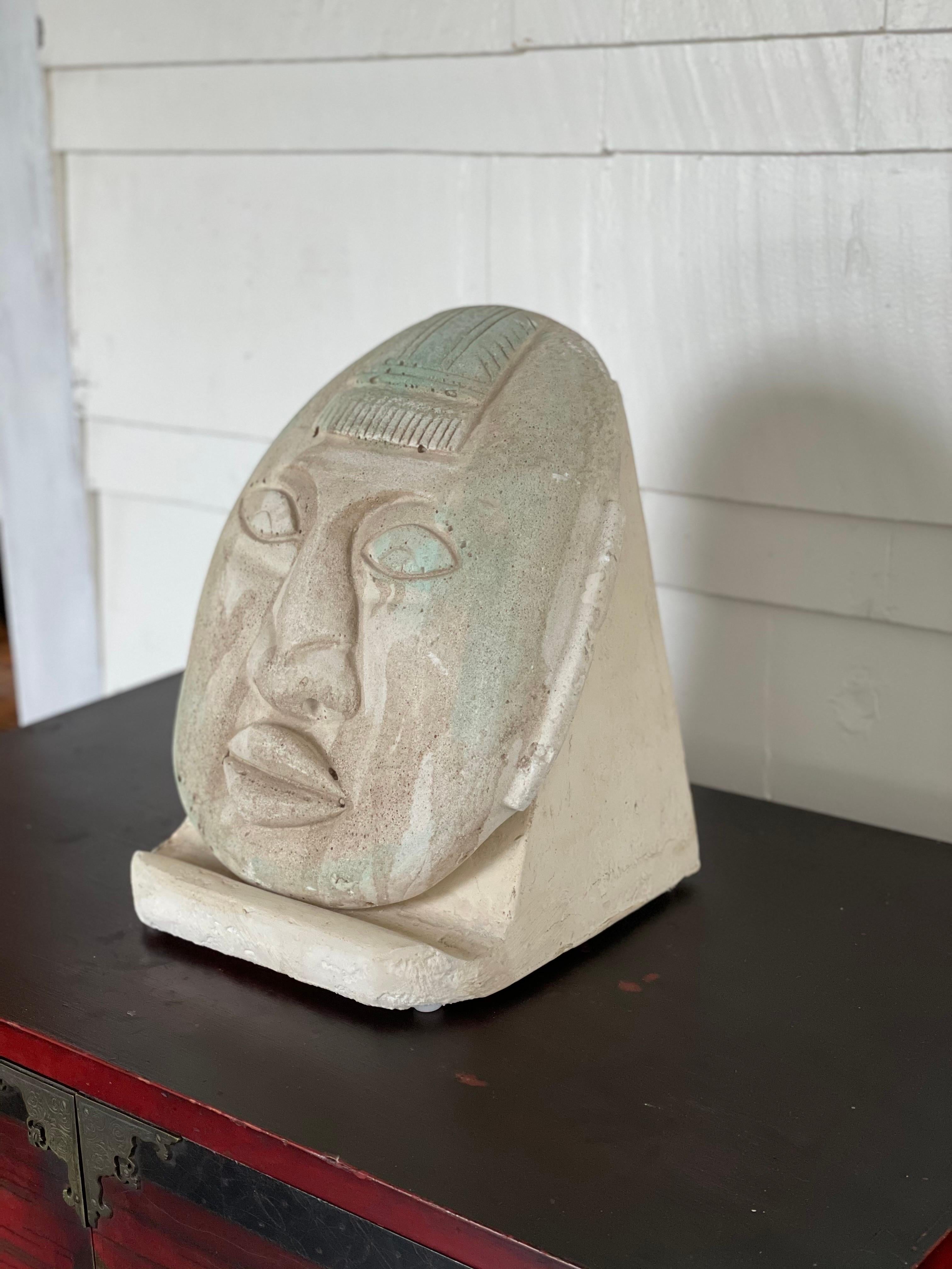 Unique postmodern plaster face sculpture with stand. Mayan or Buddha design. Great period piece and colors.