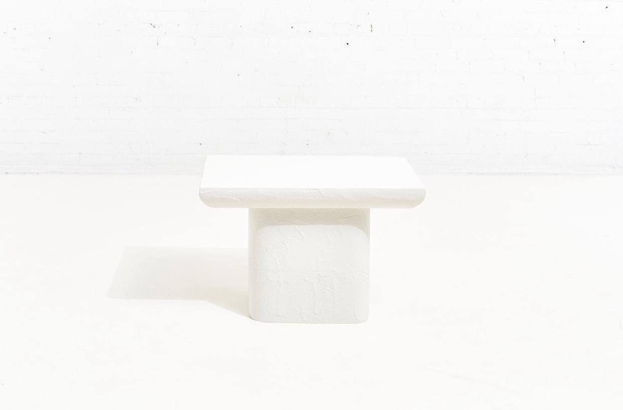 Postmodern plaster side table, 1970. Chic form with knife edge top.