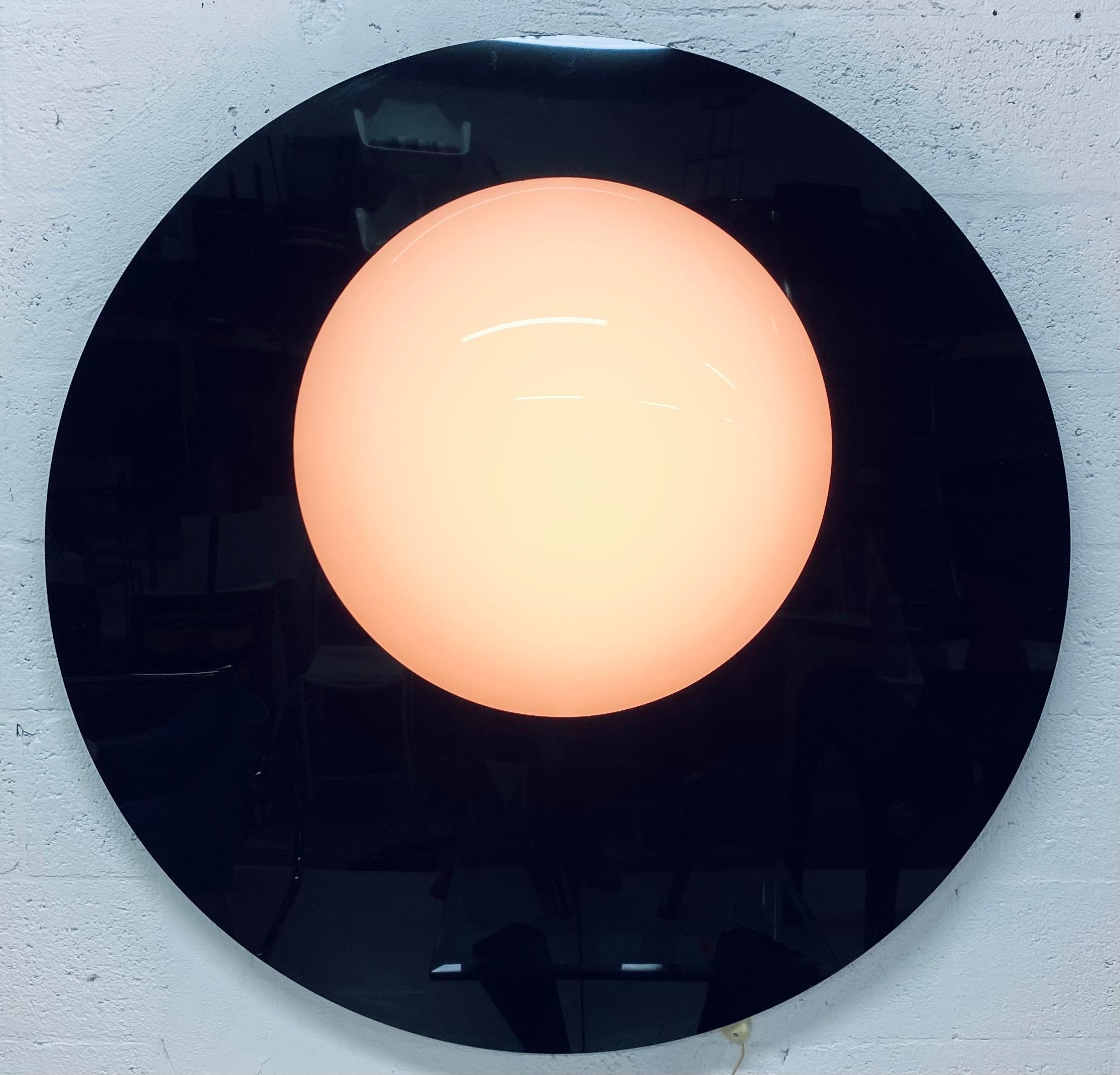 Black and white moulded plexiglass wall mounted lamp sculpture that resembles a lunar eclipse from the 1980s. Can be mounted four ways (see images).