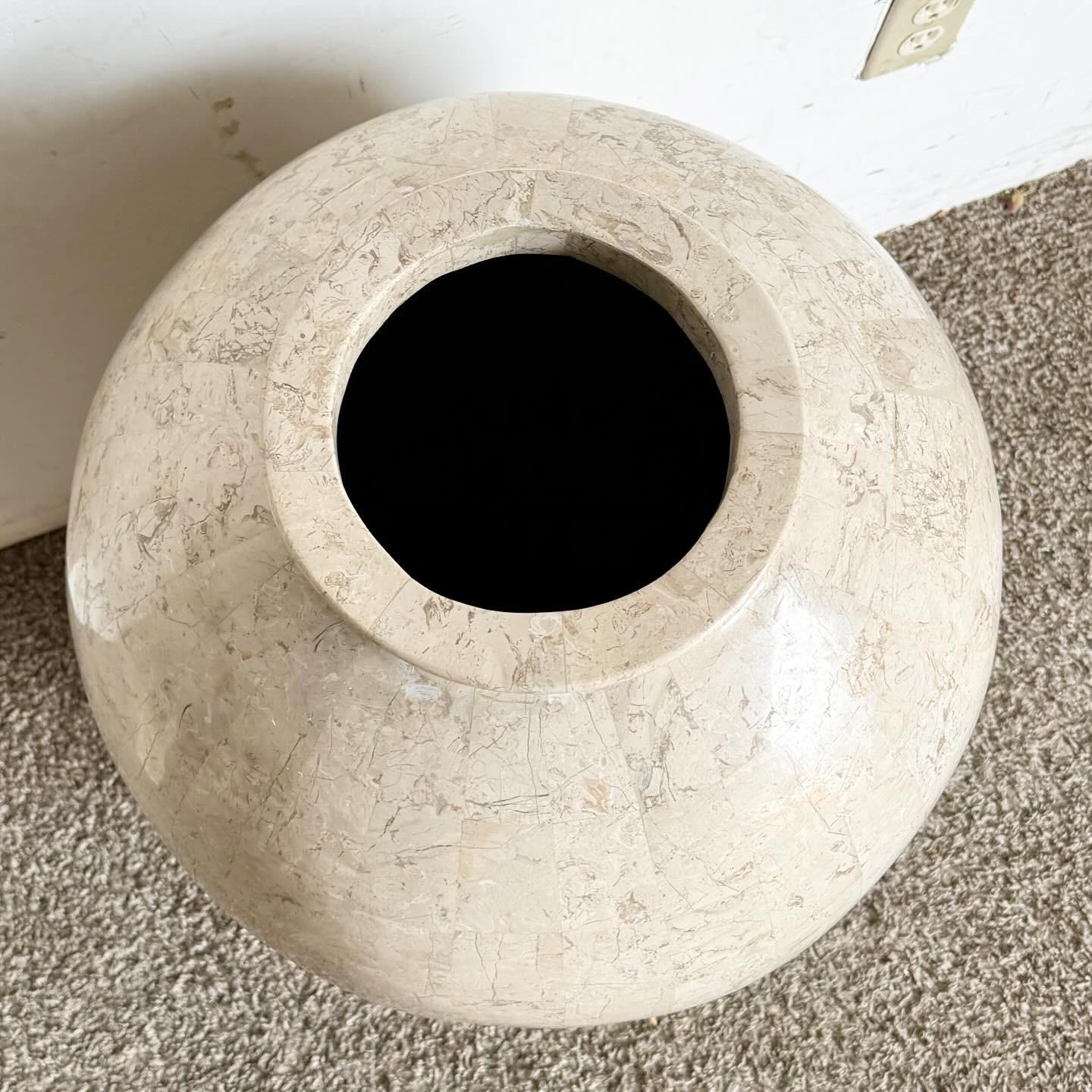 Elevate your decor with this Postmodern Polished and Raw Tessellated Stone Floor Vase. Featuring a mix of polished and raw stone, this vase offers a unique visual and textural contrast. Its geometric shapes and clean lines are perfect for