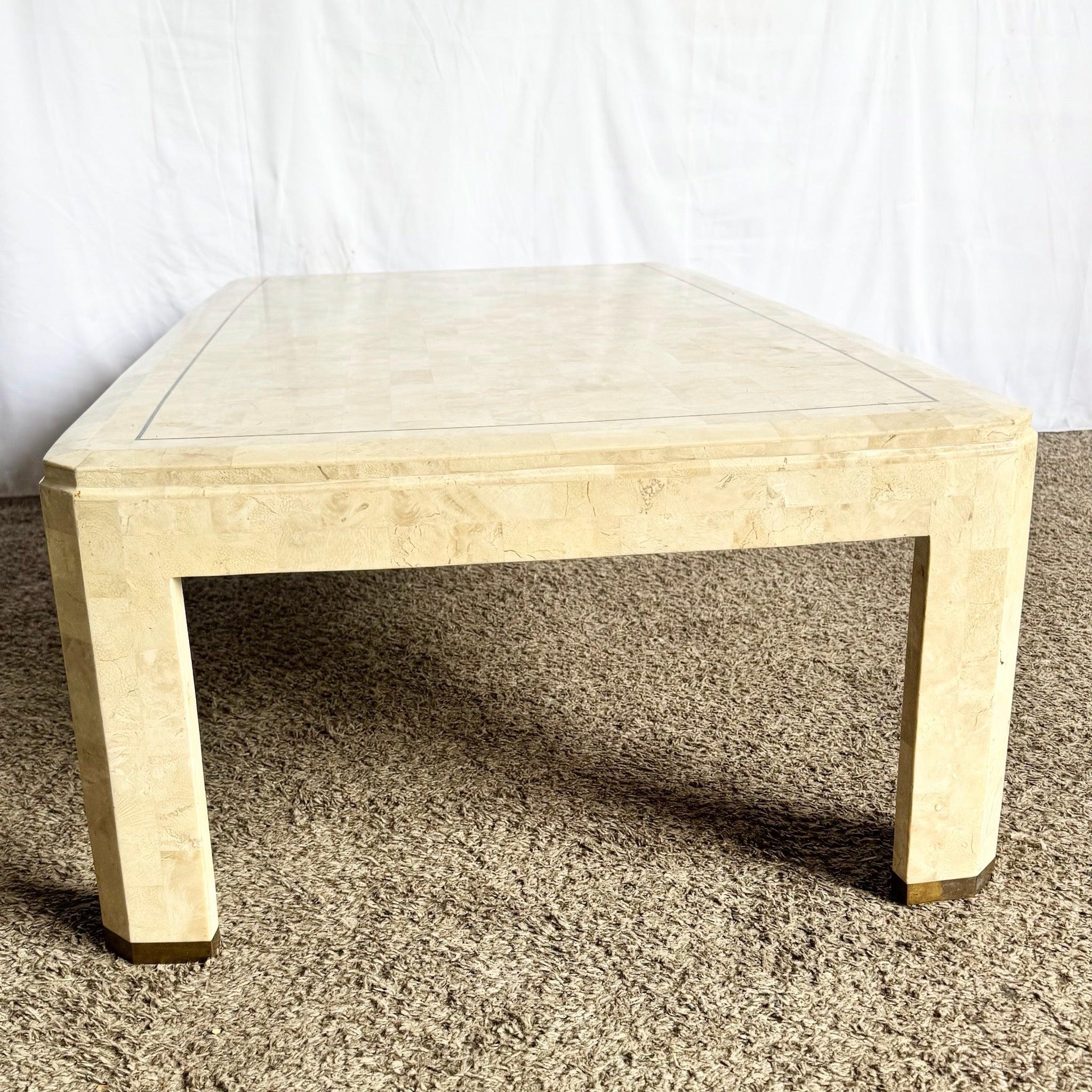 Postmodern Tessellated Stone Coffee Table with polished stone surface and brass inlay—1980s sculptural centerpiece offering refined glamour and function.
 

 A piece of stone is missing from the corner as shown in the photos. 
 

 We sell items as