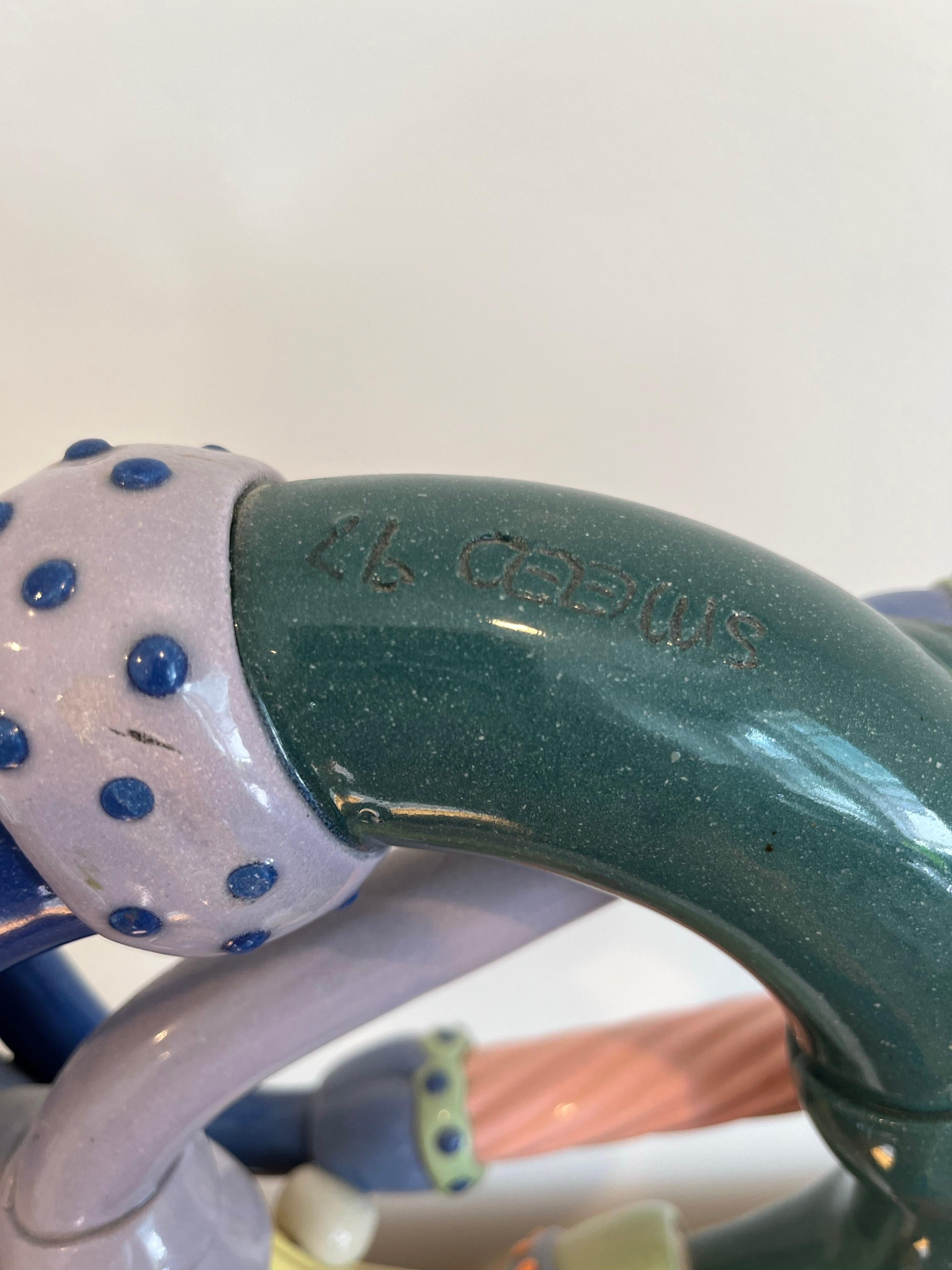Whimsical pottery French Horn by Steve Smeed 1997. Steve Smeed has made a variety of unusual and sometimes whimsical bugles.  They are instruments of a combination of extruded, slab-built, wheel-thrown and slip-cast sections, assembled and fired as