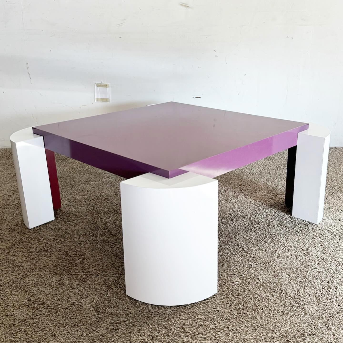 The Postmodern Purple and White Lacquer Laminate Coffee Table is a bold addition to any living space. This table showcases a high-gloss laminate finish in purple and white, offering a striking contrast. Durable and easy to clean, its rectangular